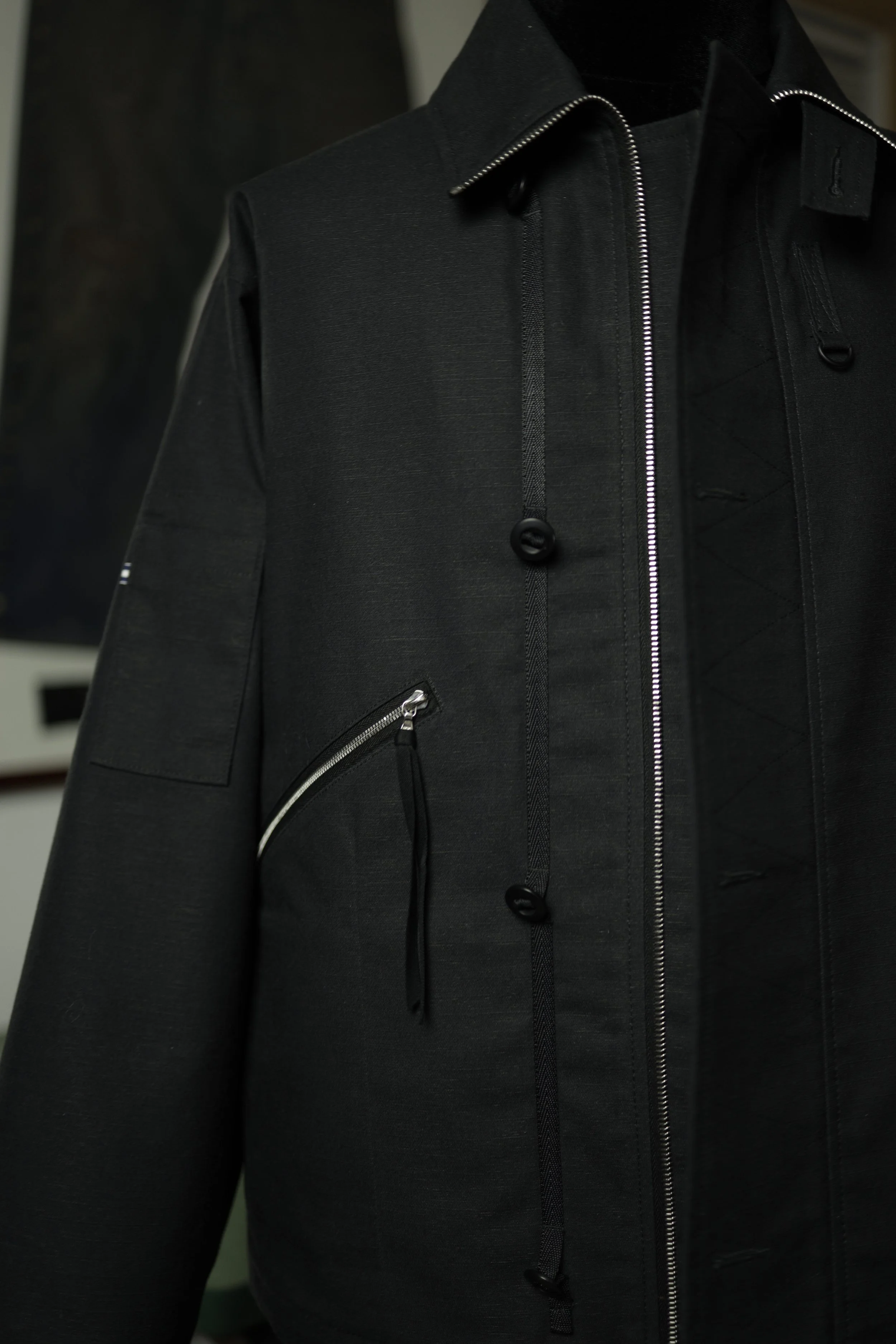 Front detail of Navigator Jacket featuring concealed zip closure and utility pocket construction.