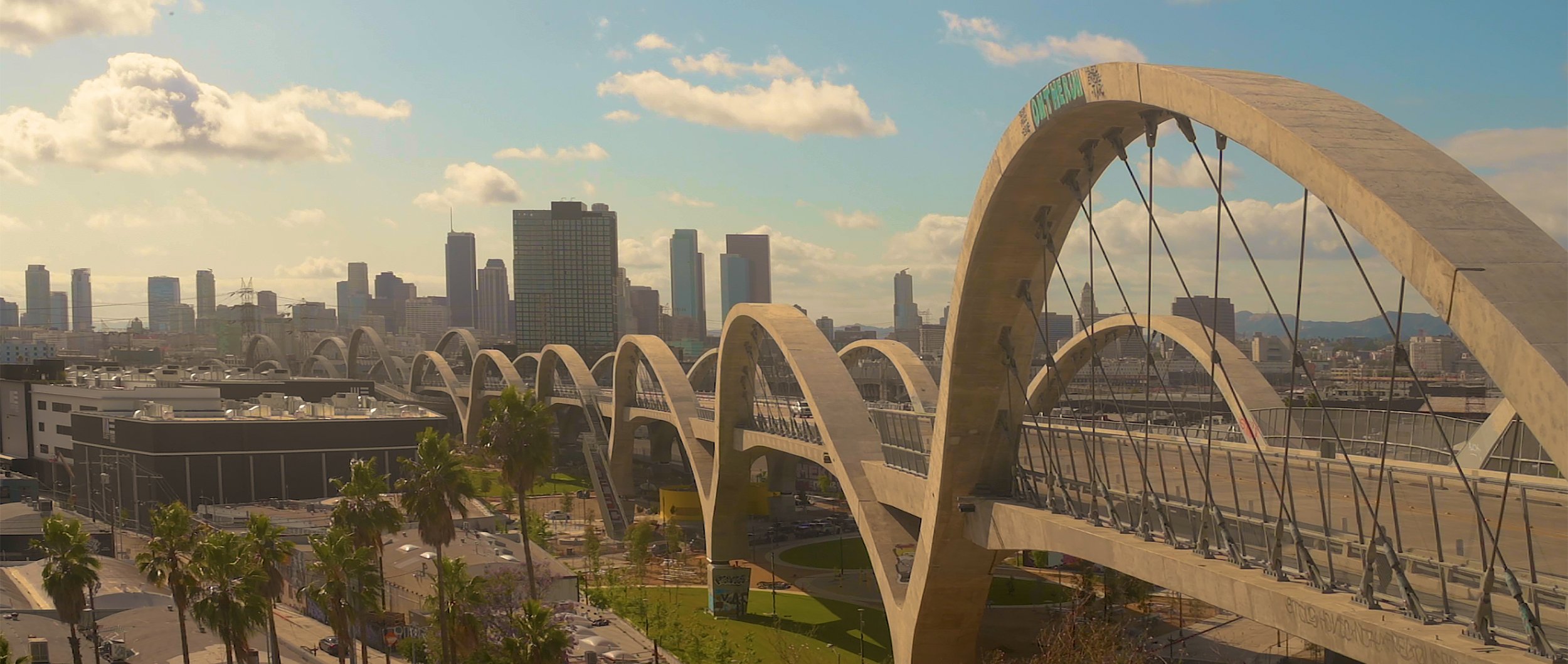 Anamorphic wide shot of 6th street bridge overlooking downtown Los Angeles, CA