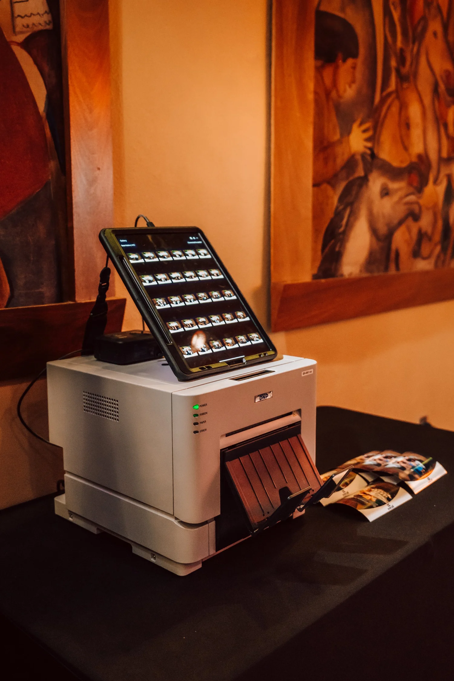 On-site printer producing branded 4x6 photo booth prints at a corporate event