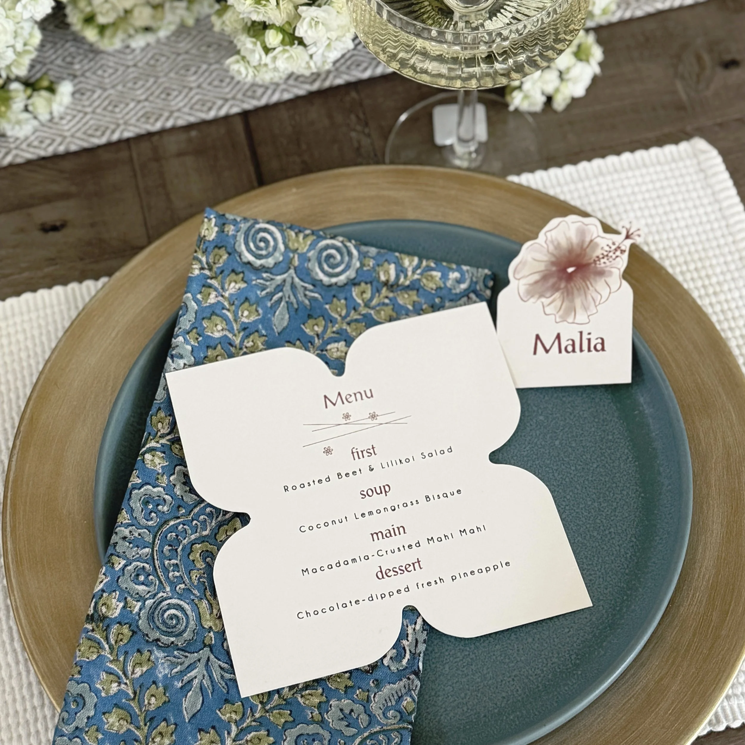 We love creating custom-shaped menus and place cards inspired by the setting. For this Hawaiian wedding, the plumeria flower was the perfect shape, while the elegant fonts helped set the tone for the celebration.