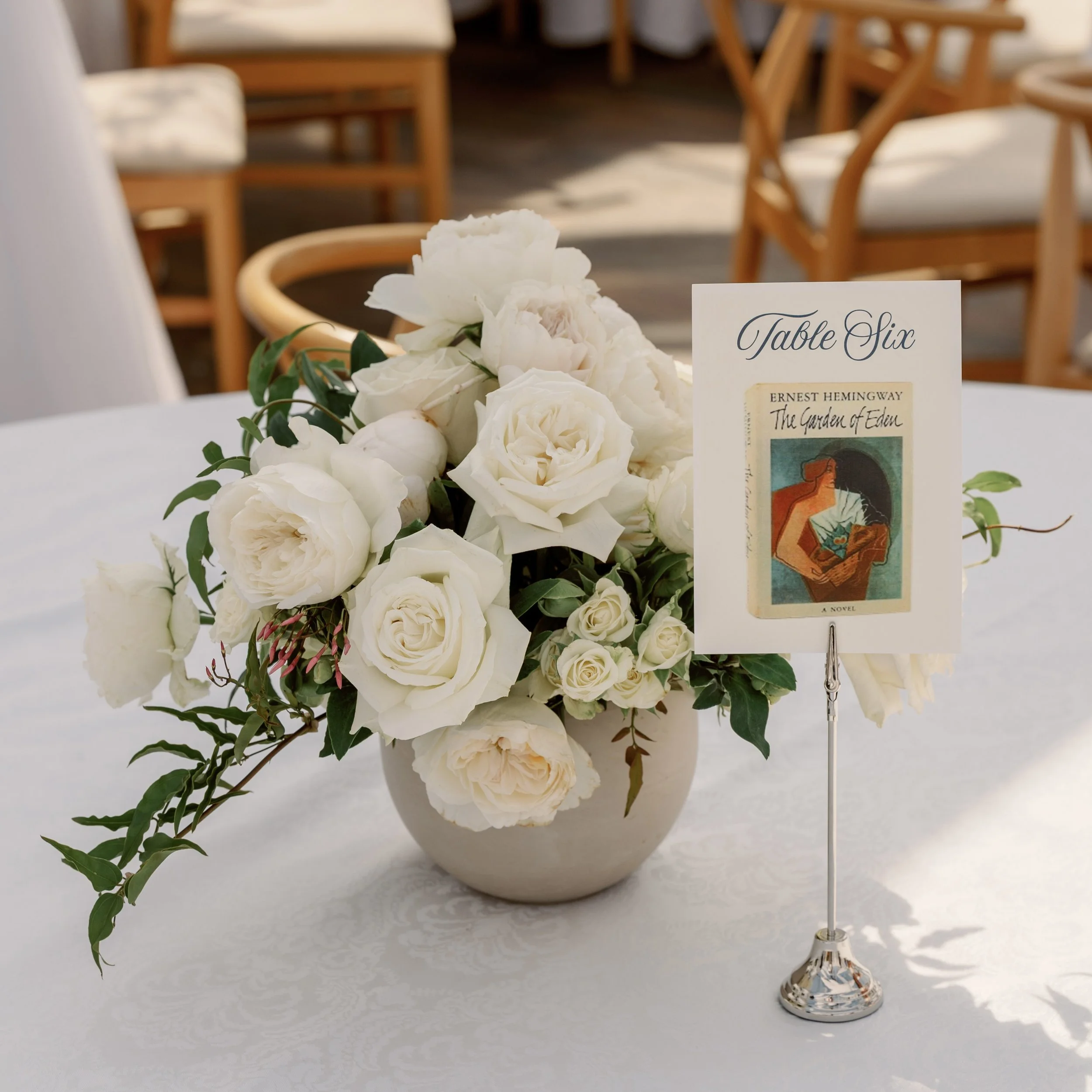 Table numbers don’t have to be ordinary. Inspired by the couple’s love of literature, each table featured a different Hemingway first edition that we pulled from a vintage poster. The seating chart echoed the same book images, and the poster itself w