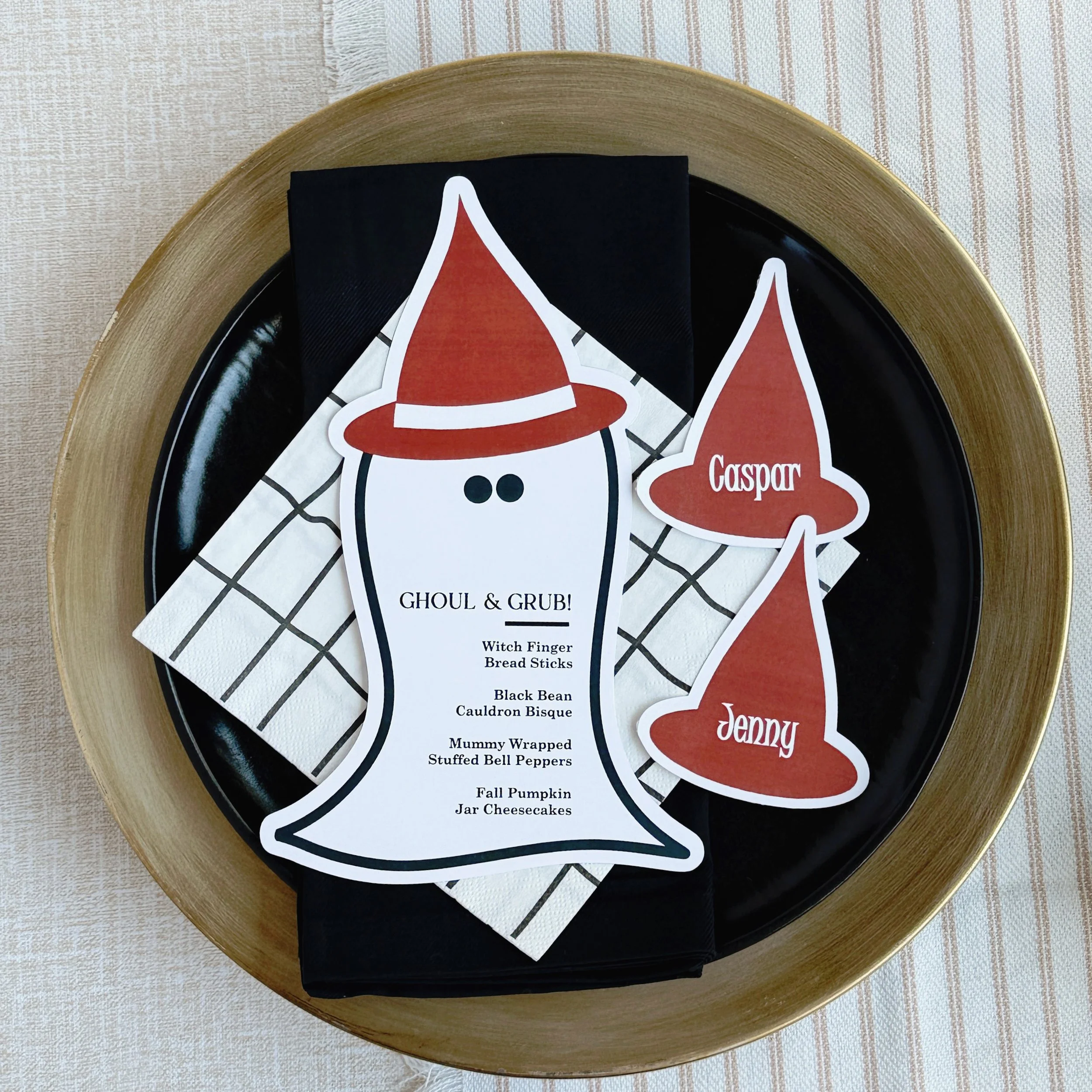 Ghosts are invited too! We loved creating this one-of-a-kind ghost menu and decided the place cards needed to match. BOOM! A playful, unexpected table setting ready for a Halloween celebration.