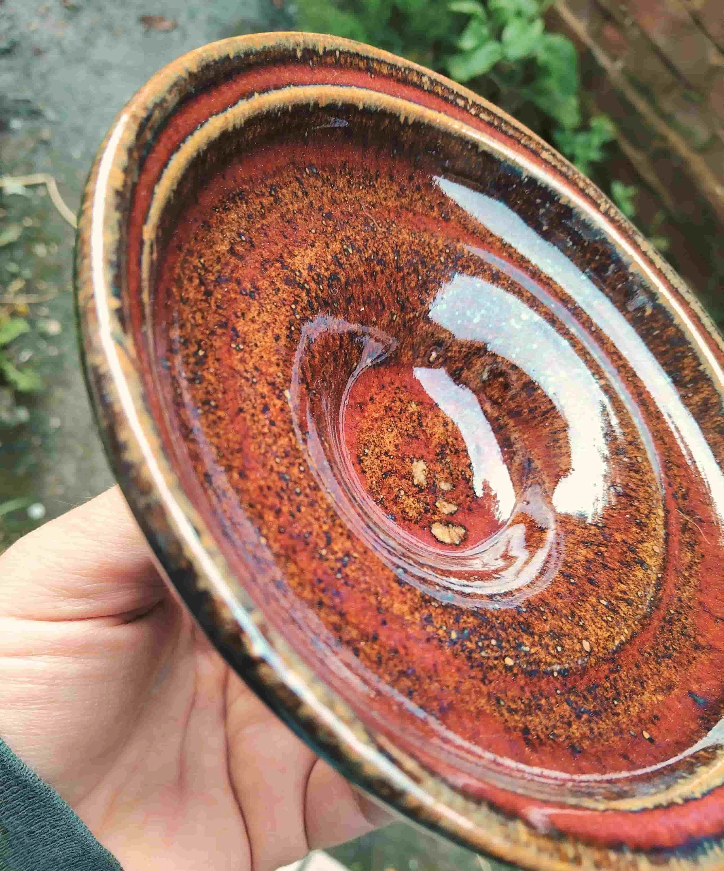 Deep red with broken tetured surface on open rimmed bowl