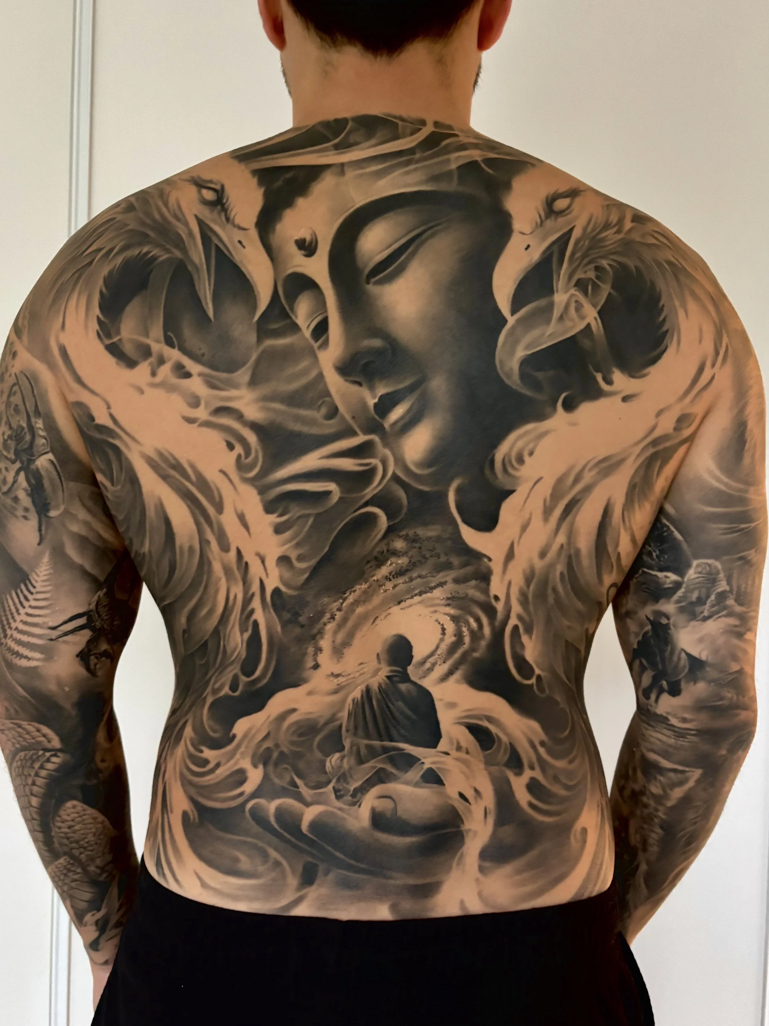 Buddha phoenix full back black and grey realism done by Ray at Markd Tattoo Sydney