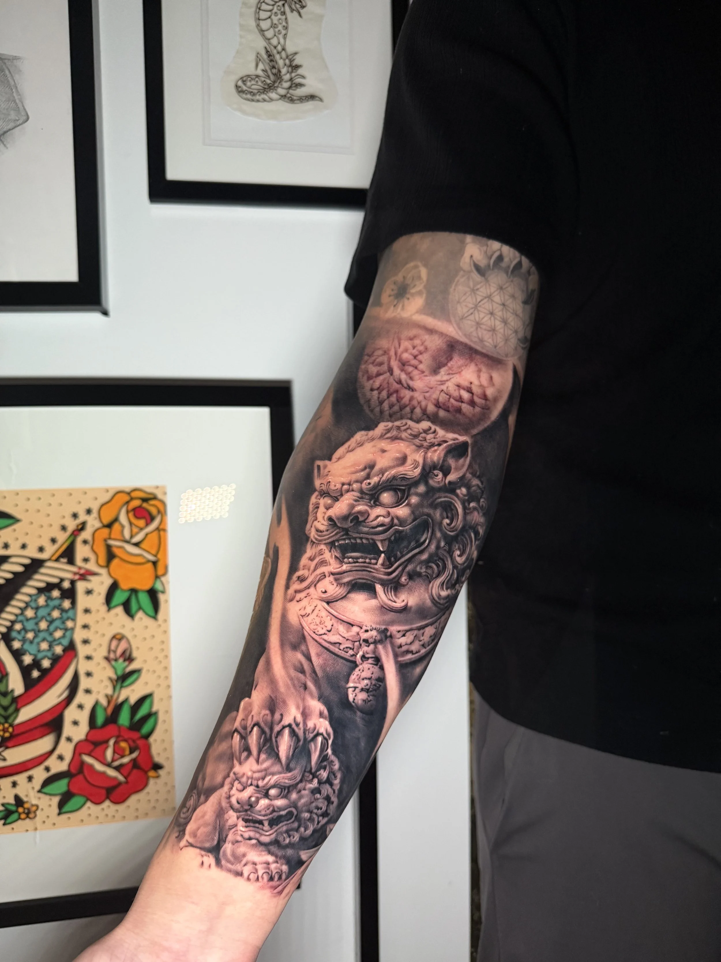 realism foo dog on the inner forearm by black and grey realism sydney based tattoo artist Ray