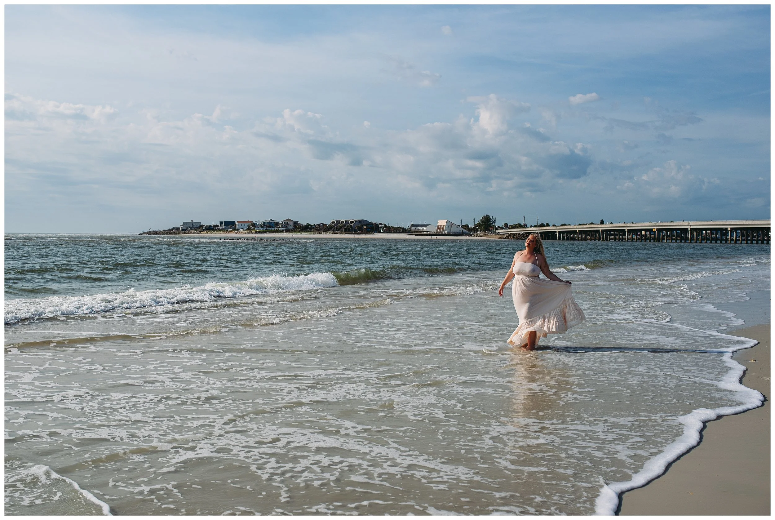 St. Augustine boudoir photographer capturing woman walking barefoot along the beach at sunrise