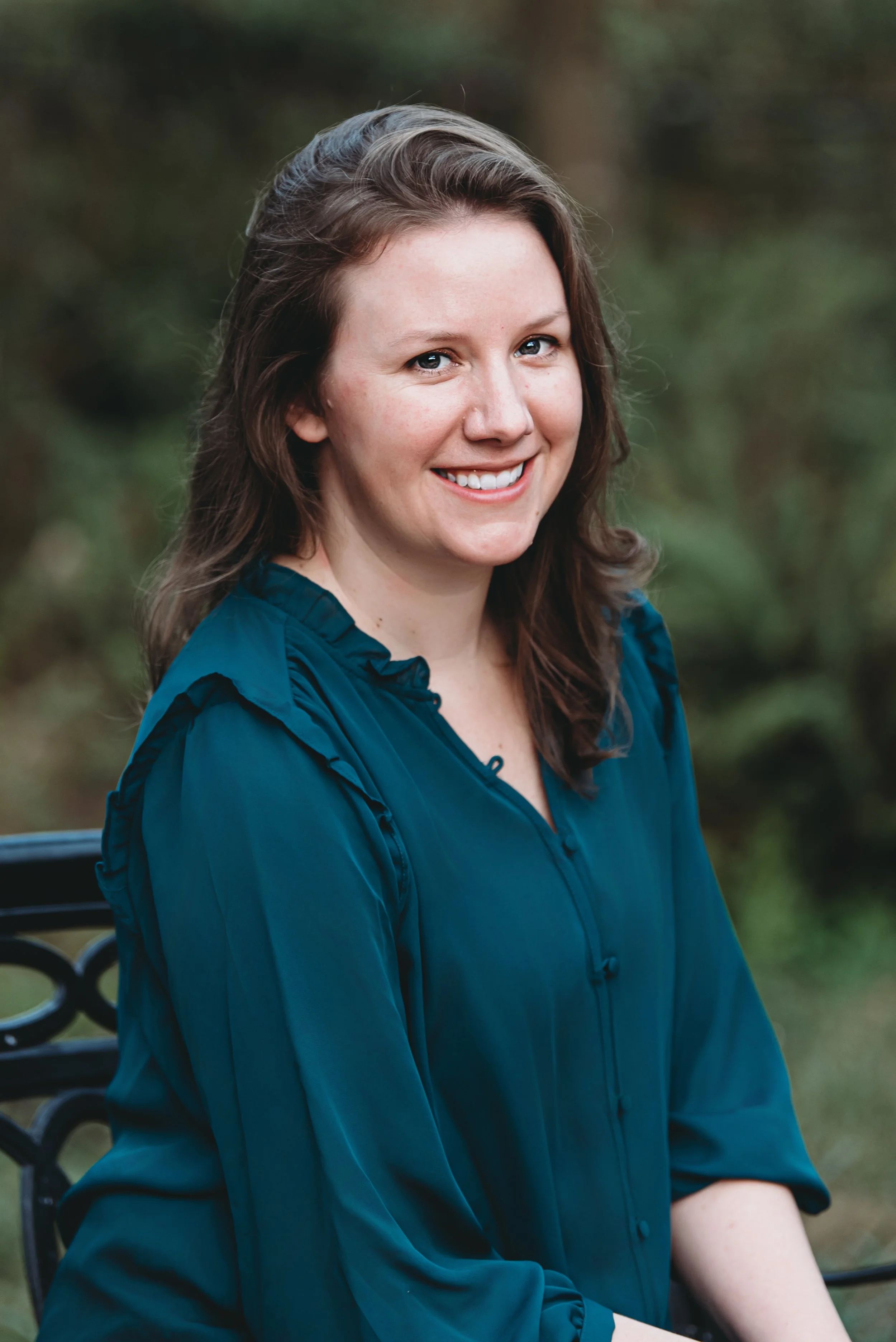 Melissa with Beloved Bits Boudoir sitting in green top outside