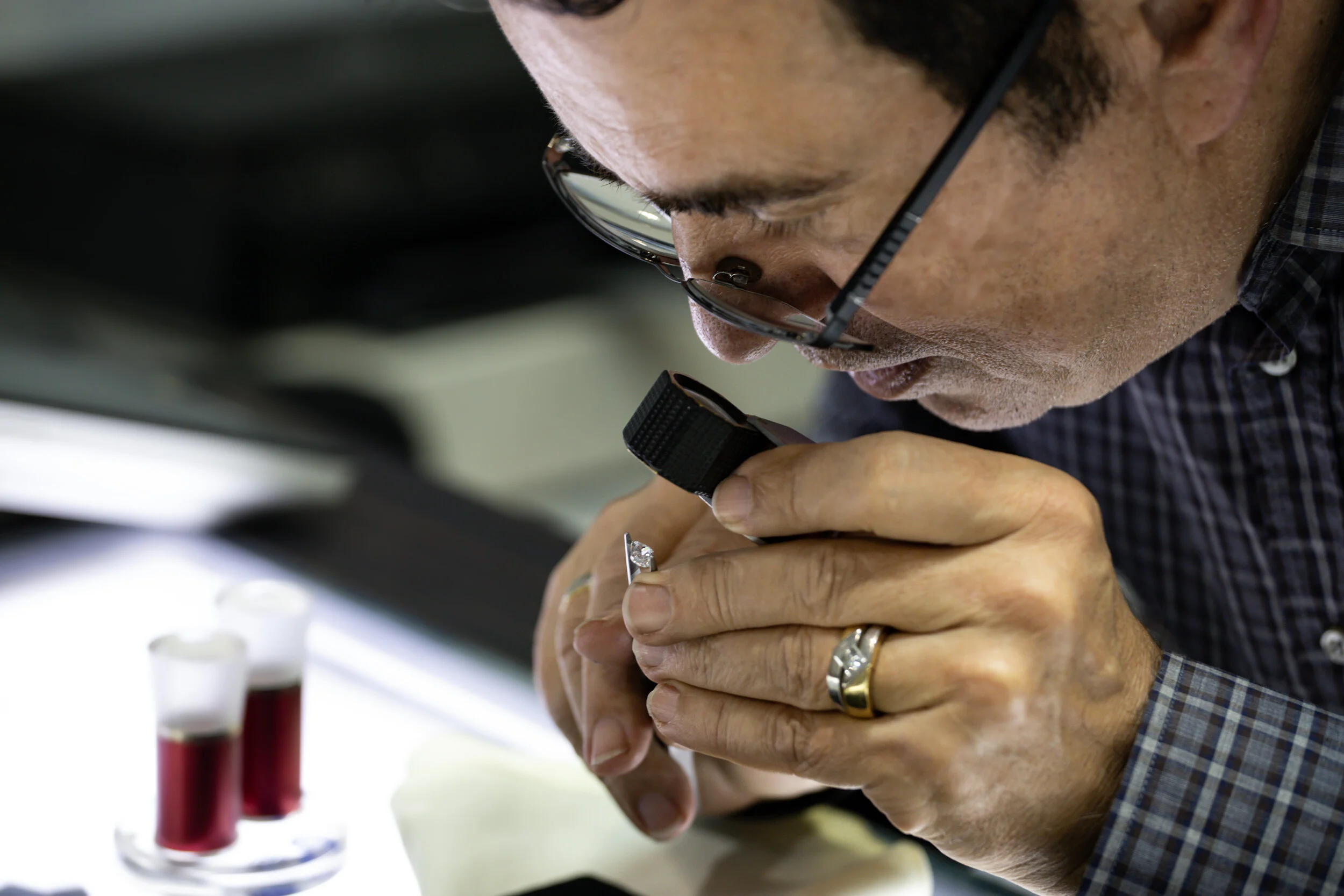  Inspecting the diamonds against their report. 