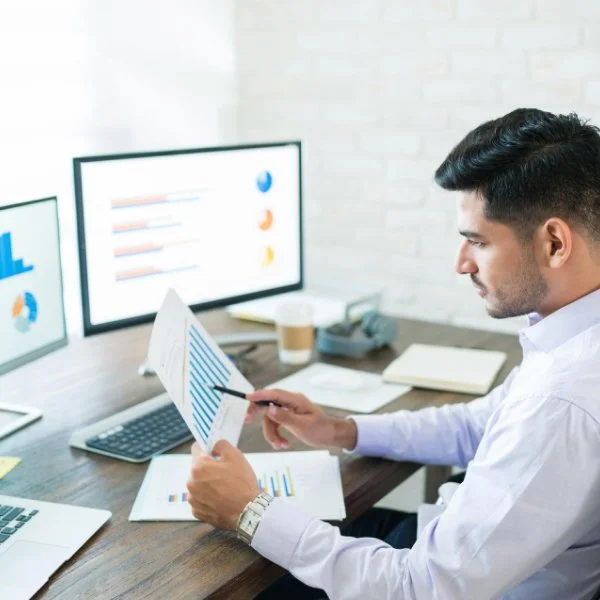 Warehouse employee labeling packages while implementing accurate inventory tracking and monitoring systems.