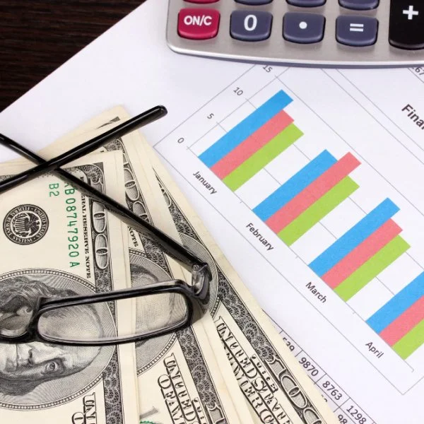 Financial documents and sales performance charts used to forecast demand and support strategic business planning