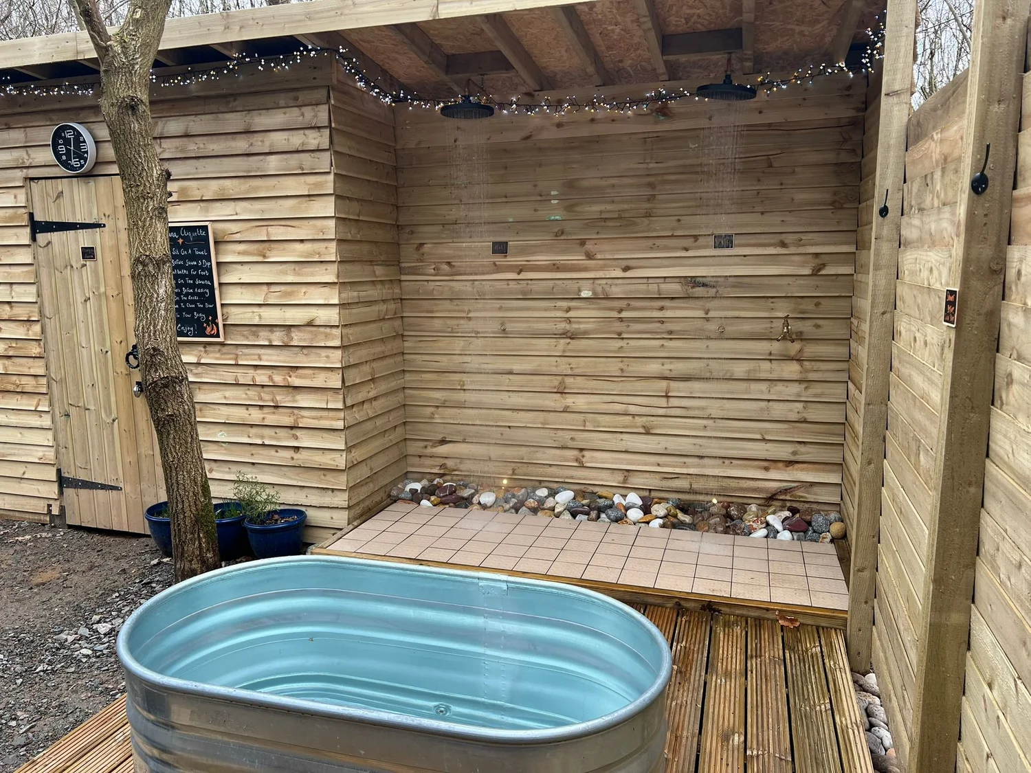 Outdoor showers beside the Fire and Stars Woodland Sauna