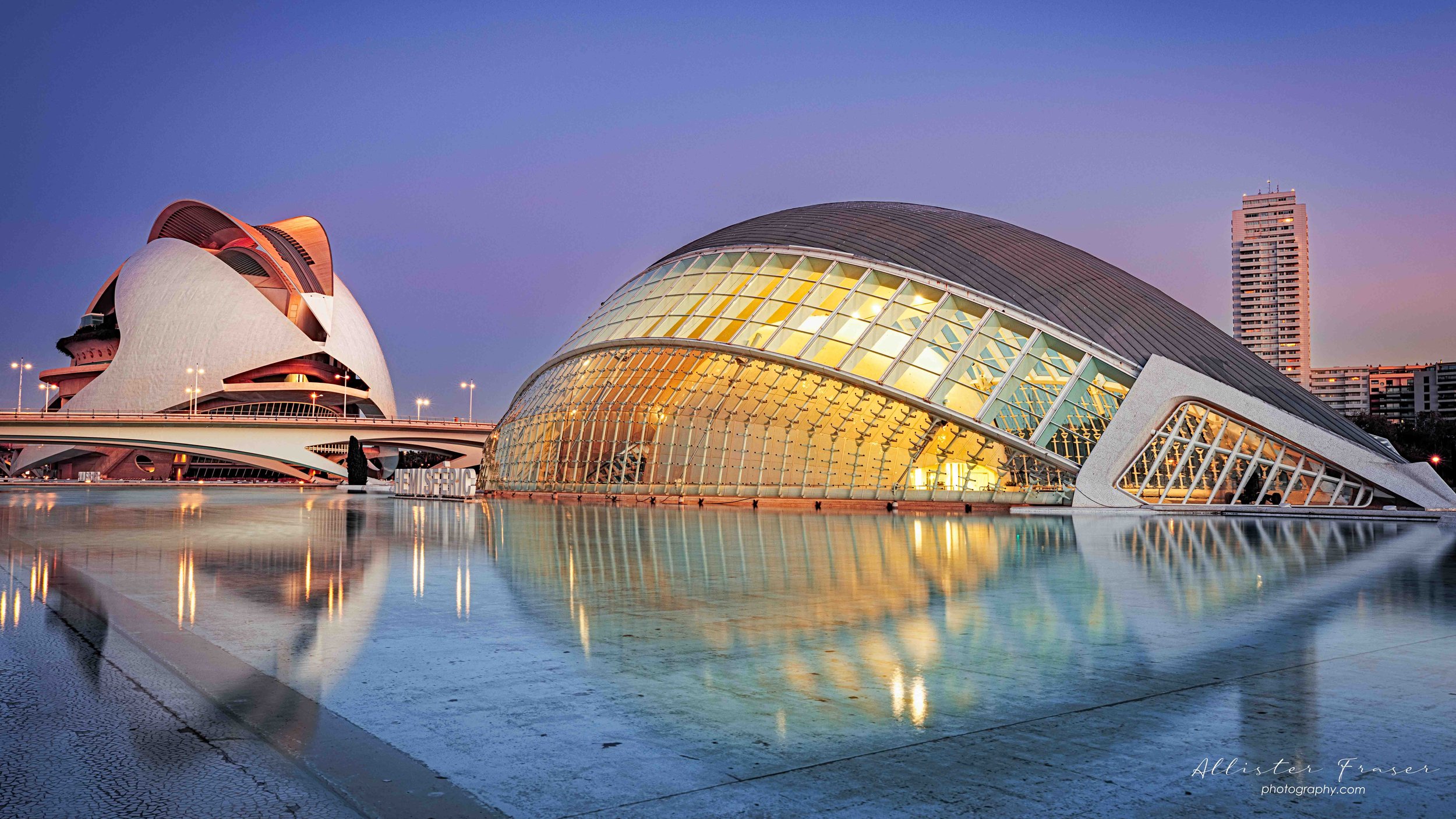 sunset with light on at the hemispheric and palace of the arts.