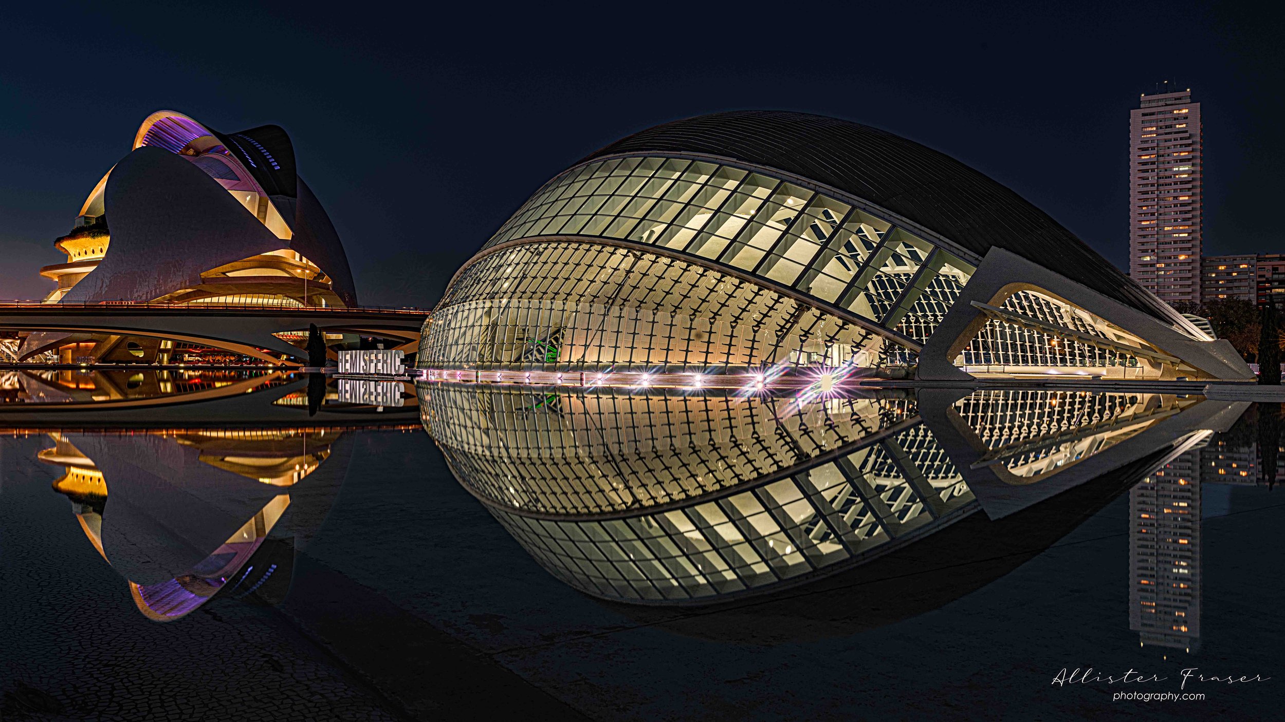 the palace of arts lit up for an evening opera with the hemispheric playing a supporting role