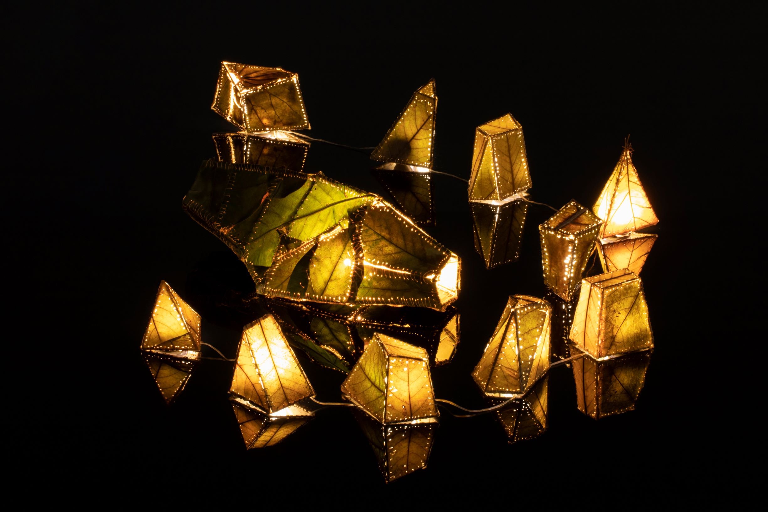 Magnolia and Oak leaves, bamboo, nylon sutures used in cosmetic procedures. (Smaller lanterns: 4 x 4 x 5 inches) Augmented is a three-dimensional work that pulls together biological textures with the ideals of the human desire for control and beauty.