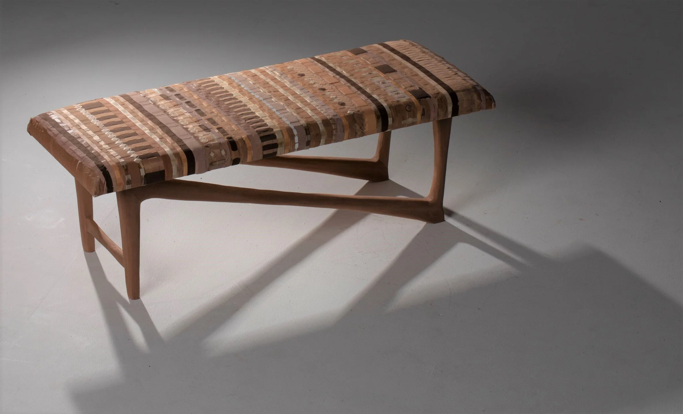 Possibility plays with notions of identity, territory, and borders, within an instantly recognizable form. Using hand-carved Sapele lumber and traditional joinery techniques, the legs are designed to emulate the body. Shadow’s cast along the natural