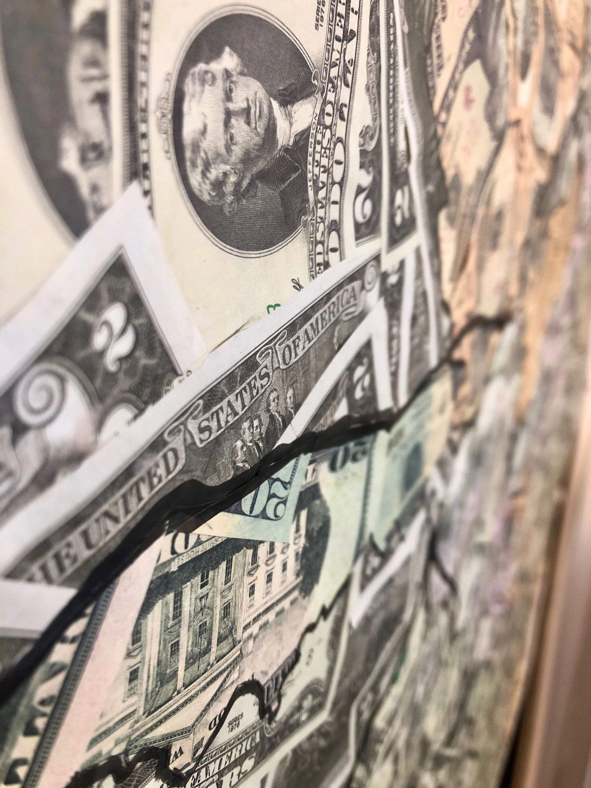 Close-up of crumpled and overlapping US dollar bills, including denominations of two, twenty, and fifty dollars.