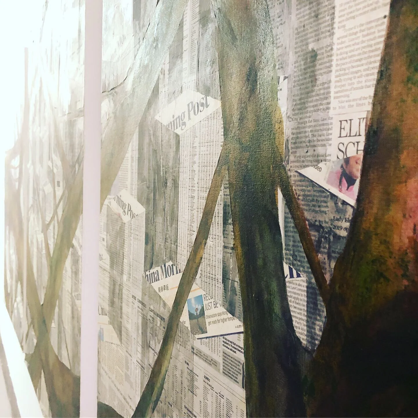 A wall covered with newspapers and newspapers' headlines, with wooden poles and mountain-like textures.