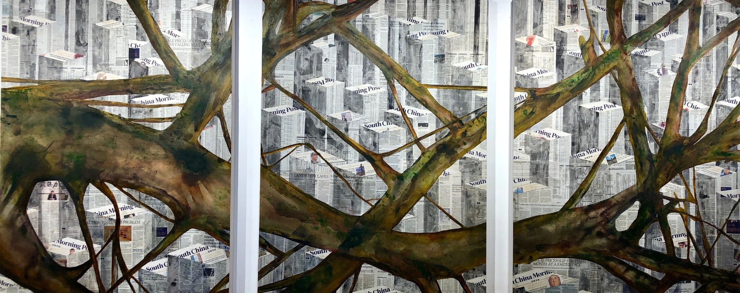A building wall decorated with a mural resembling tree branches over a background of newspaper pages.