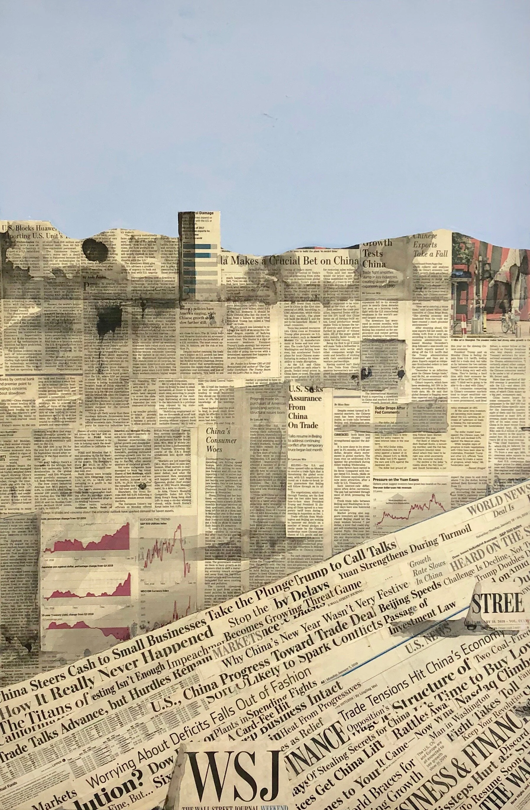A collage of torn newspapers arranged to resemble a city skyline, with a blue sky and clouds in the background.