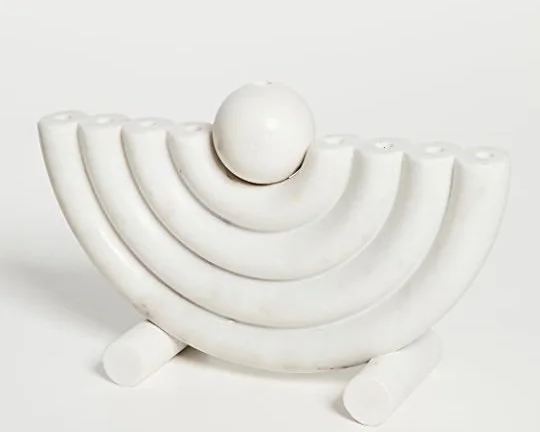 Luxury Hannukah décor for home. A menorah carved out marble and designed by CoCo Ree Lemery.