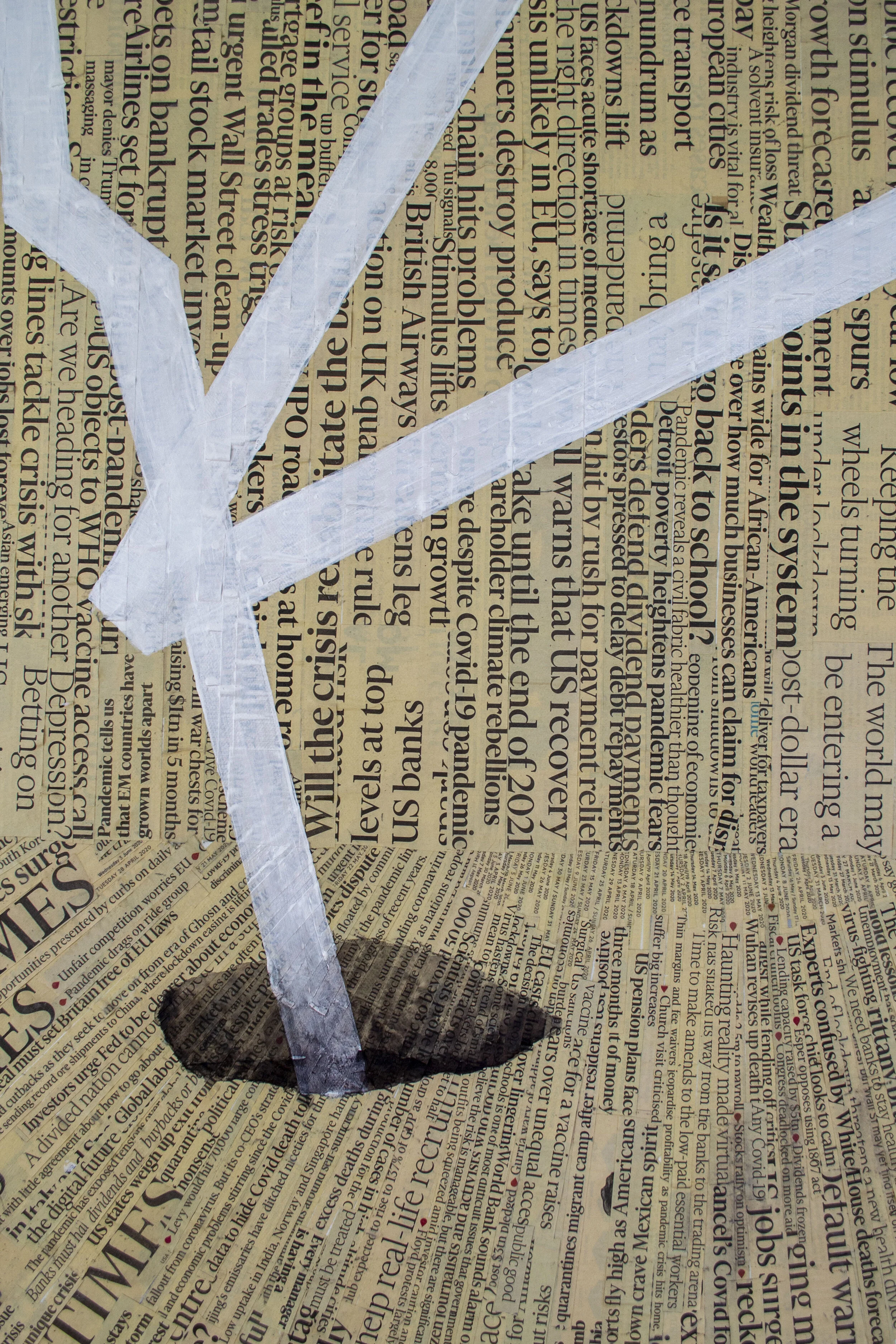 A painted paper knife with gray and white colors placed over a background of newspaper text.