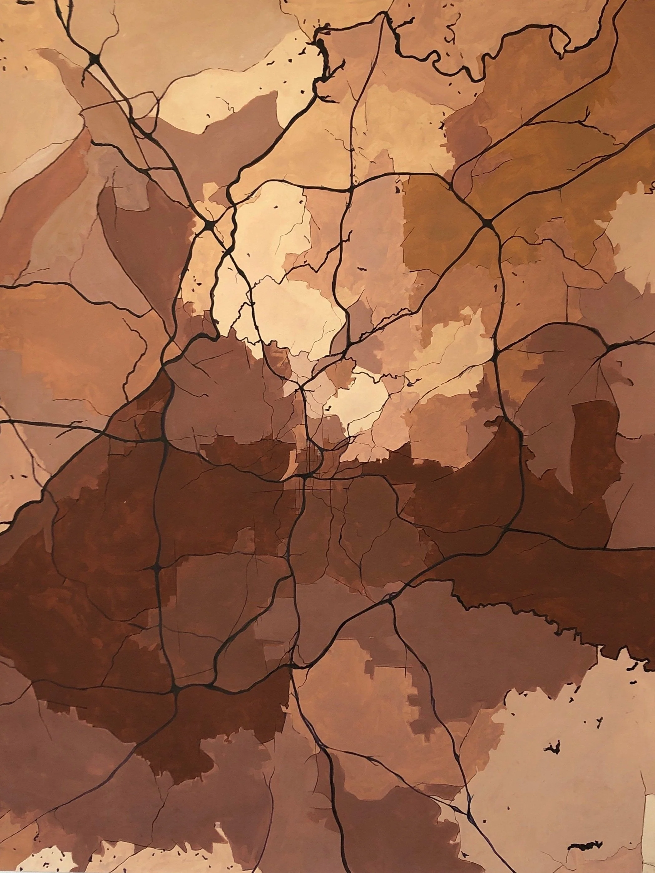 Abstract map of a city with black streets and various shades of brown in the background.