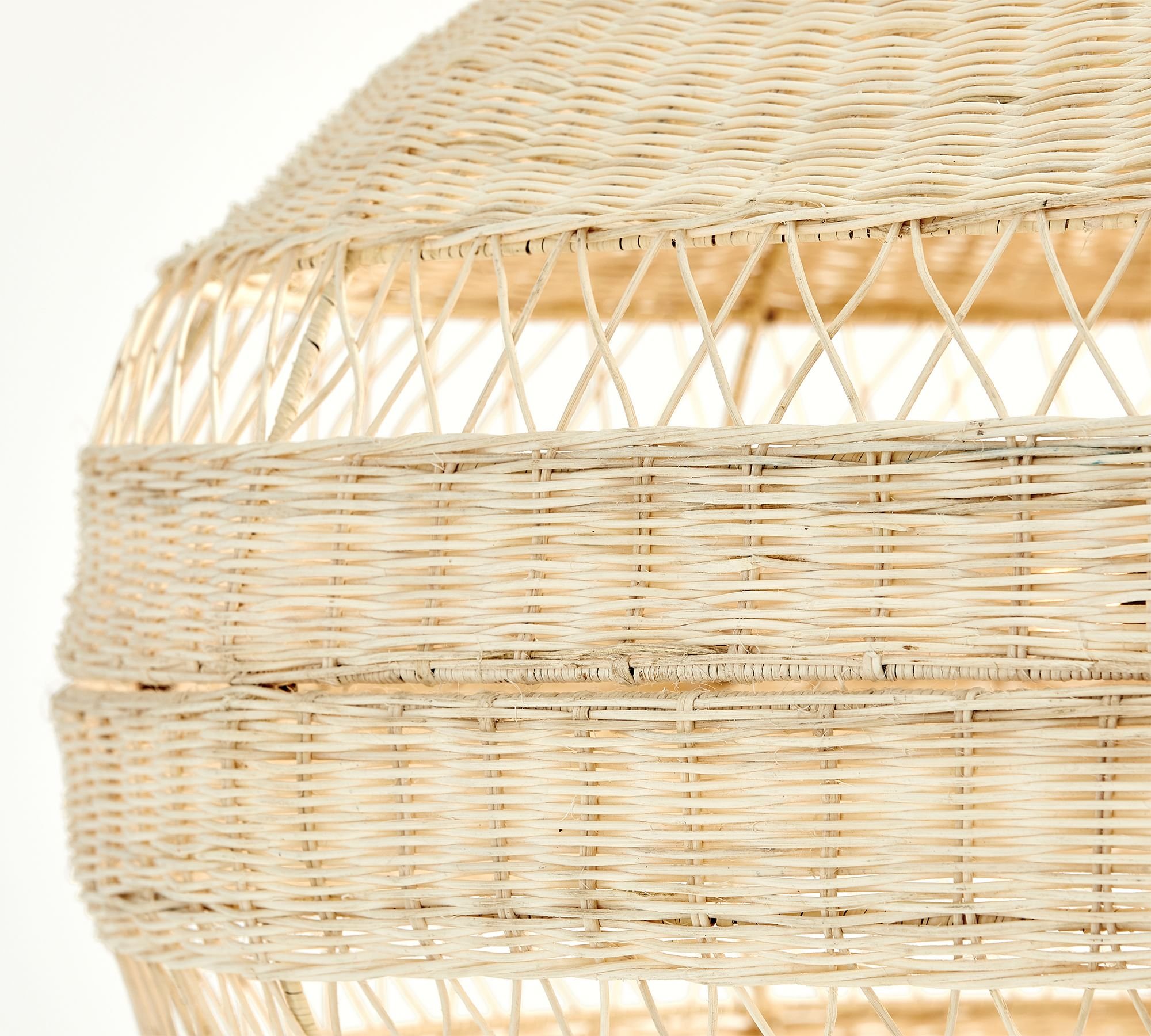 Man-made from mother nature, this inviting collection diffuses light softly through a filigree of woven rattan. Whether it recalls summer at the seaside or bohemian chic, each piece has a substantial scale that makes it an ornament for any room.