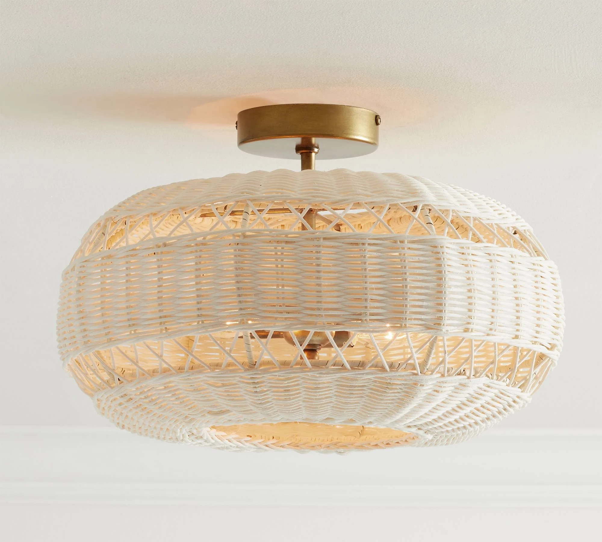 Man-made from mother nature, this inviting collection diffuses light softly through a filigree of woven rattan. Whether it recalls summer at the seaside or bohemian chic, each piece has a substantial scale that makes it an ornament for any room.