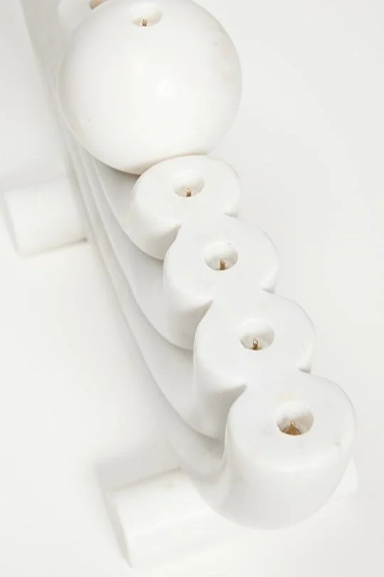 Luxury Hannukah décor for home. A menorah carved out of white marble and designed by CoCo Ree Lemery.
