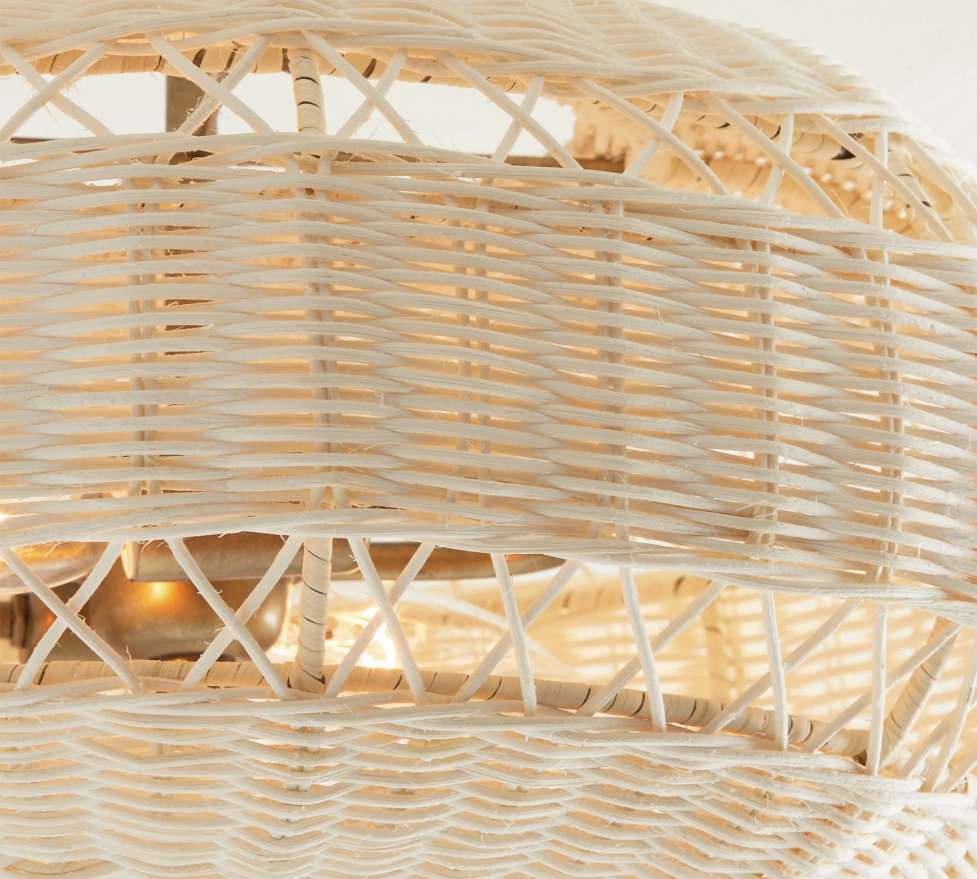Man-made from mother nature, this inviting collection diffuses light softly through a filigree of woven rattan. Whether it recalls summer at the seaside or bohemian chic, each piece has a substantial scale that makes it an ornament for any room.