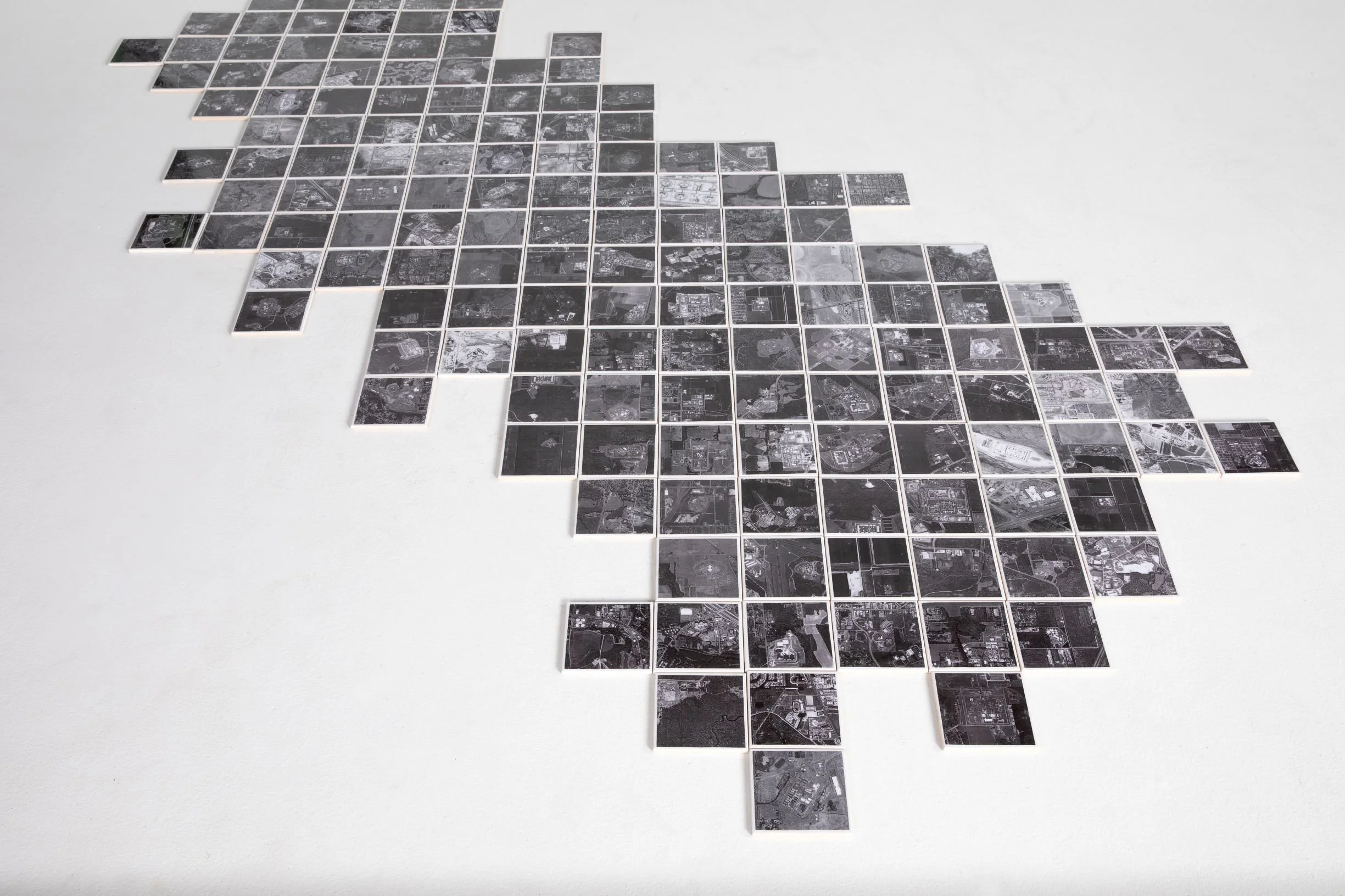 Each ceramic tile is a birds-eye view photograph of a US government or privately owned ICE detainment facility or prison.  Aiming to provide a more physical representation of US incarceration, the 160 unique tiles that can be walked on still only rep