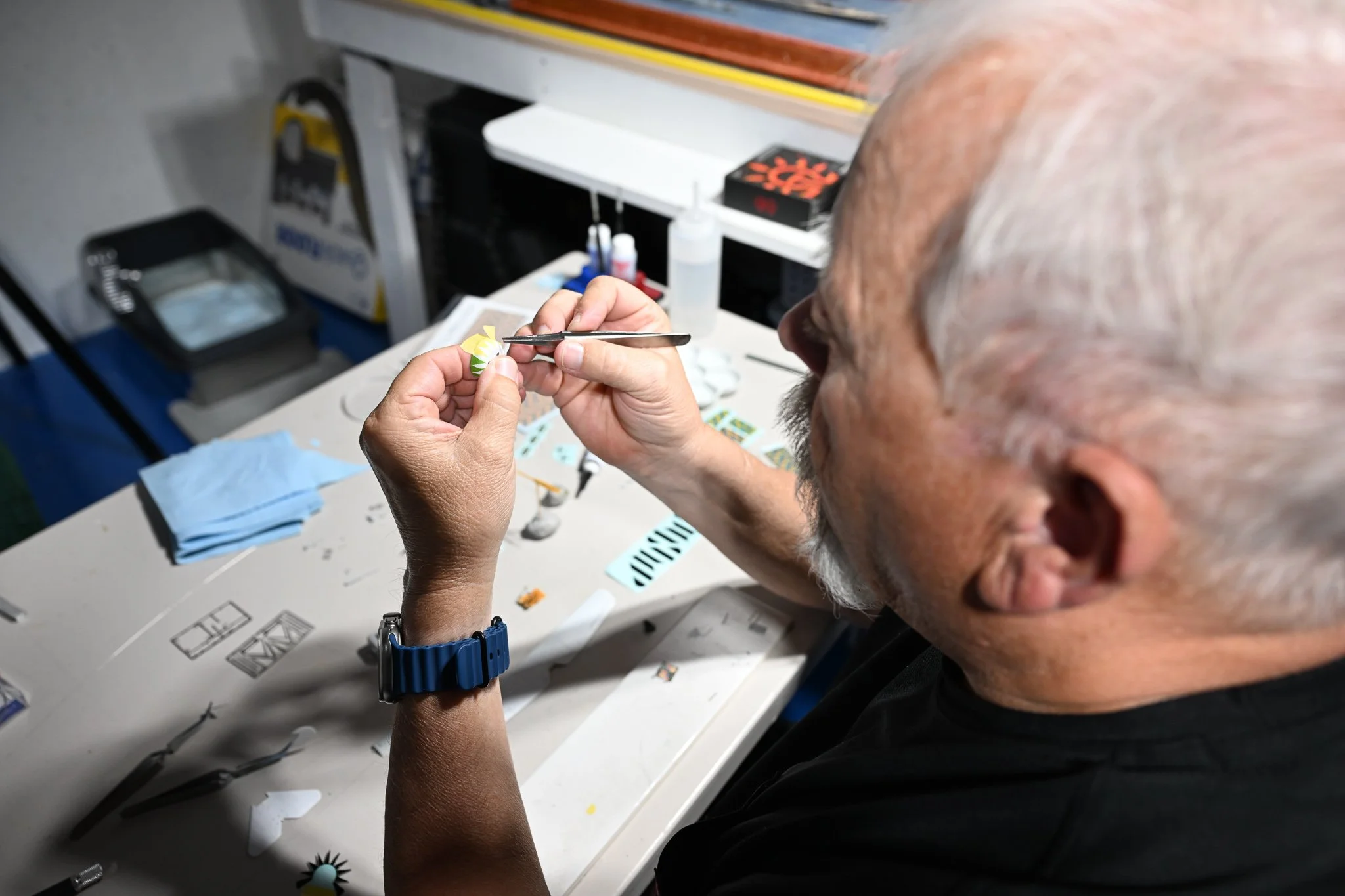 Kent Barnes gently places masking tape onto a small piece of the scale model of a World War One airplane he is currently building on Wednesday July 15, 2026, at his residence in Columbia. “This is the one part of scale modeling that is my least favor