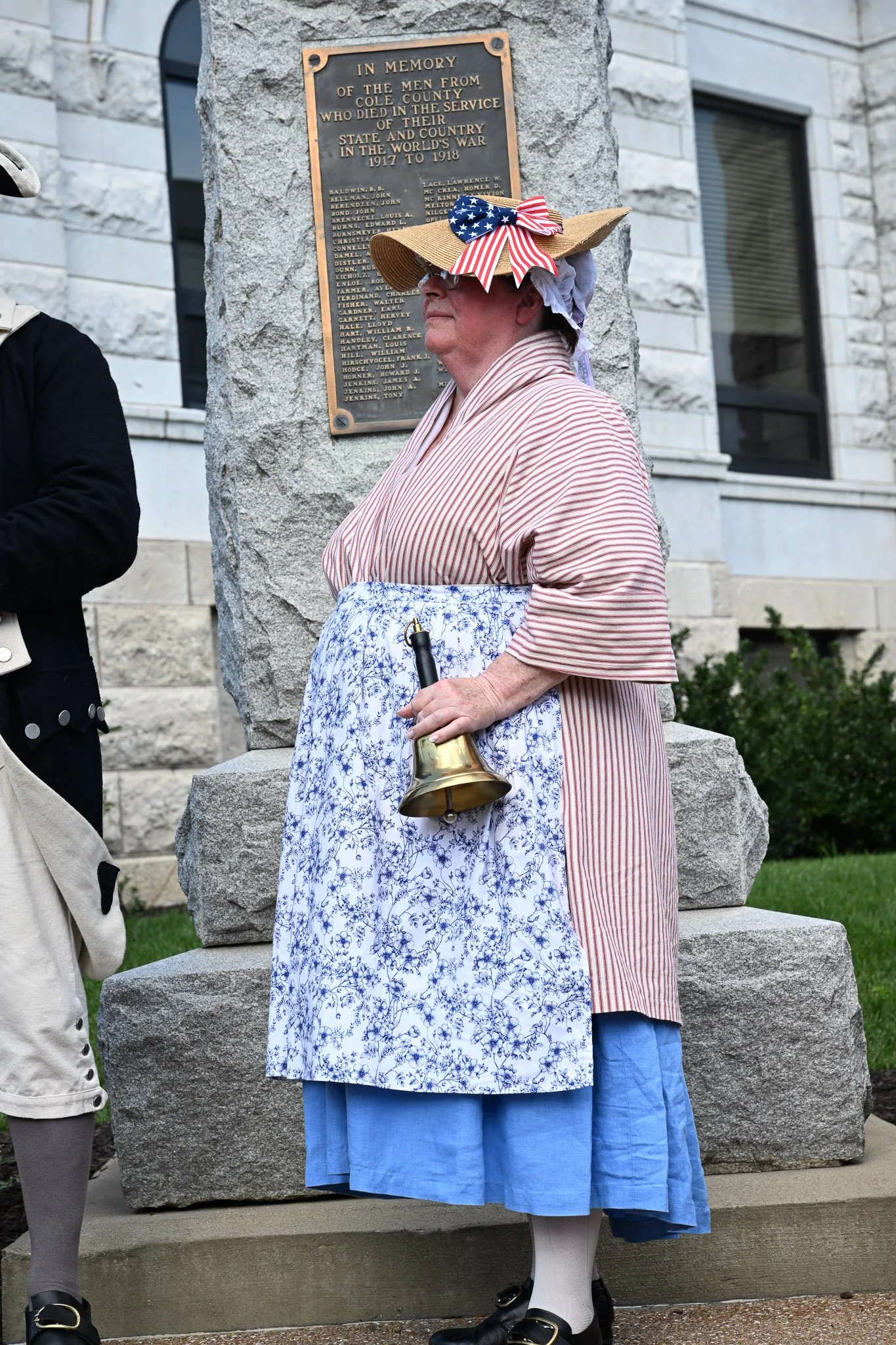 Debbie Baker portrays the bellringer, who gathered the crowd, before the reading of the Declaration of Independence on Monday, July 8, 2026, at Cole County Courthouse in Jefferson City, Missouri. Baker is an auxiliary member of the Chris Casey Chapte