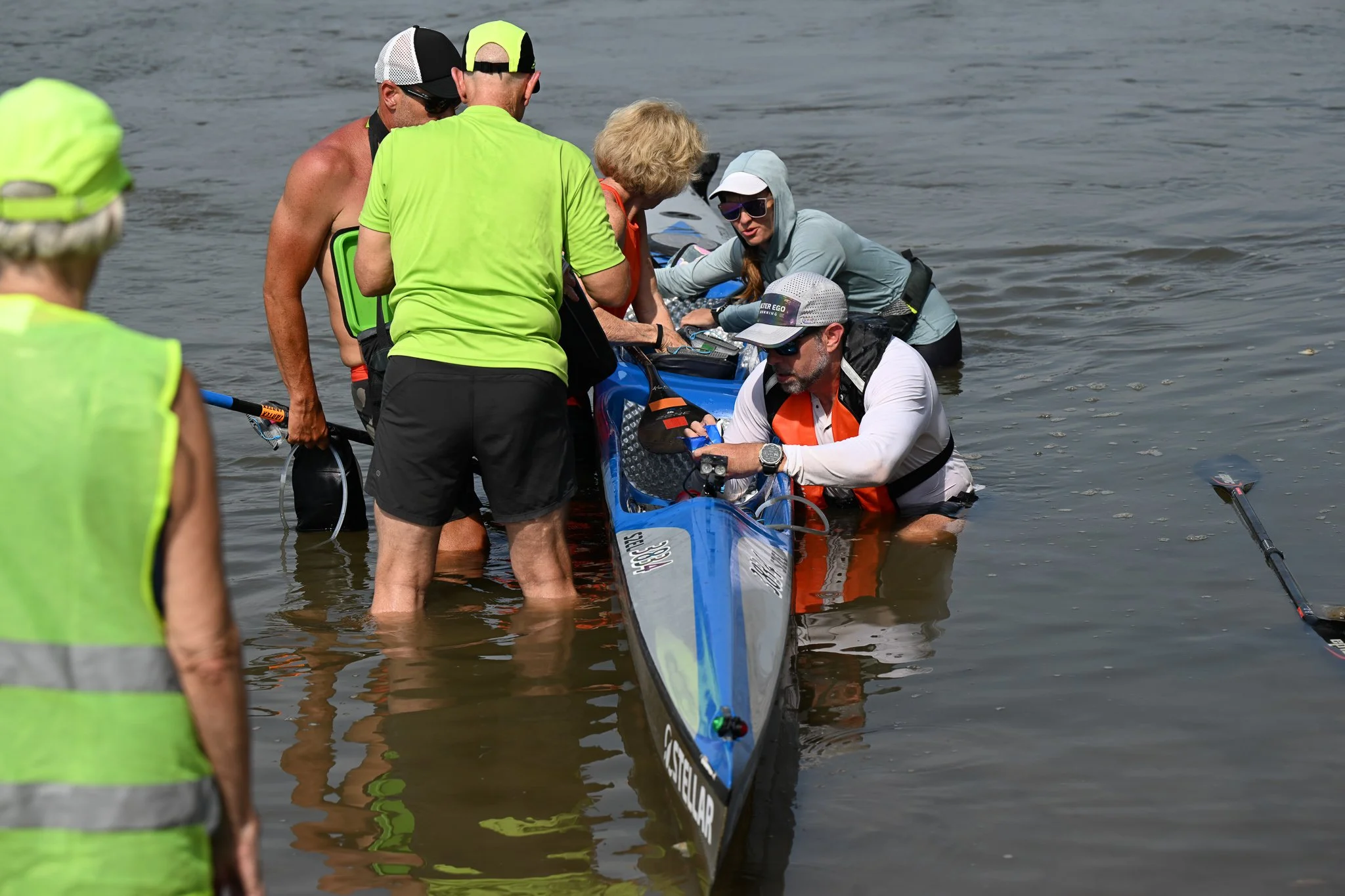 Volunteers help Brian Jones, front right, and Kristin Miller, back right, both from Texas, get their kayak “Going Concern” onto shore on Tuesday, July 28, 2026, at the Port of Waverly in Waverly, Mo. Over 600 racers began the Missouri River 340 race 
