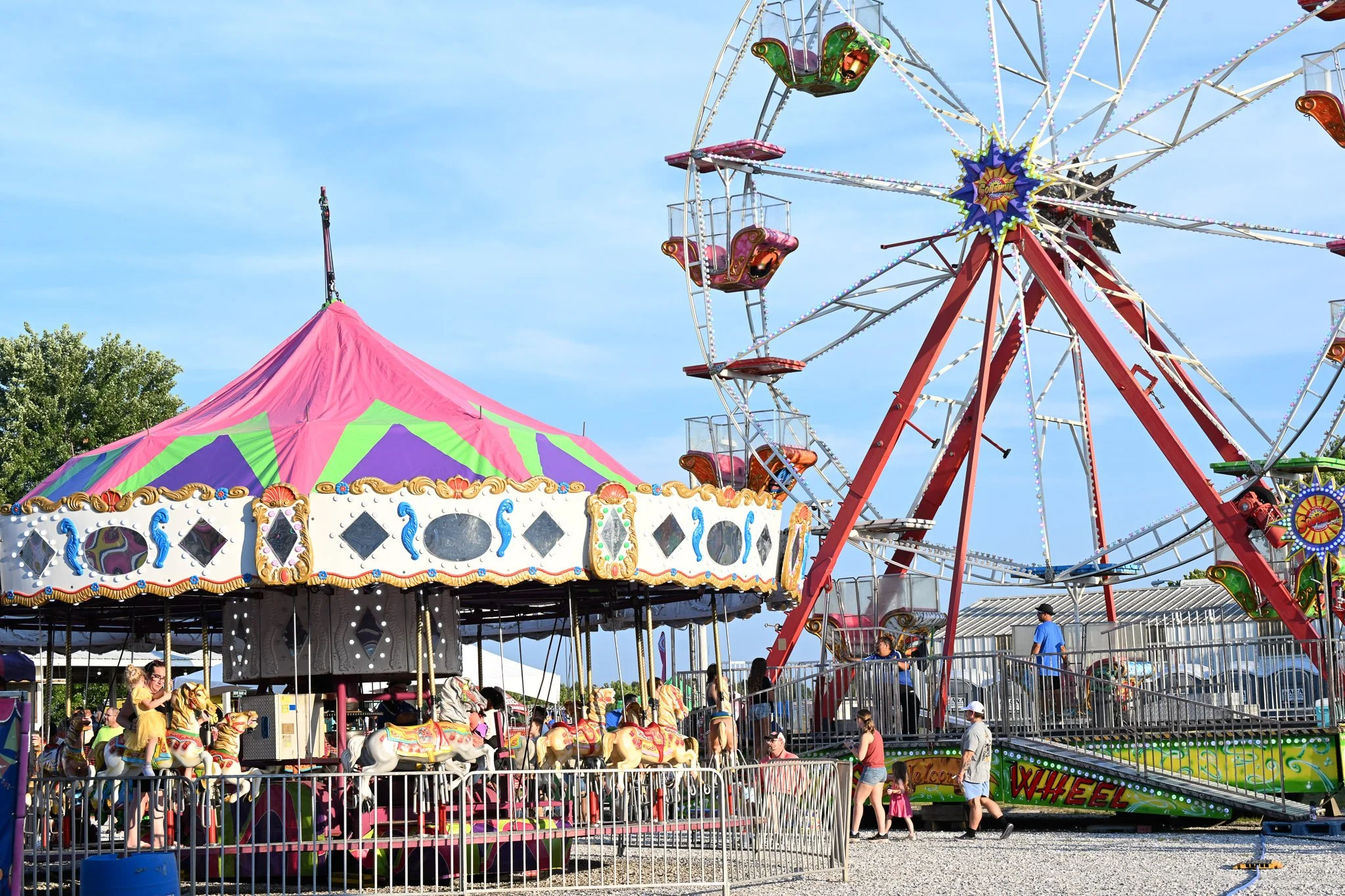 Fair patrons enjoy the carousel and ferris wheel at Boone County Fair on Tuesday July 21, 2026, Northeast Regional Park in Columbia. The Boone County runs until Saturday, July 25.