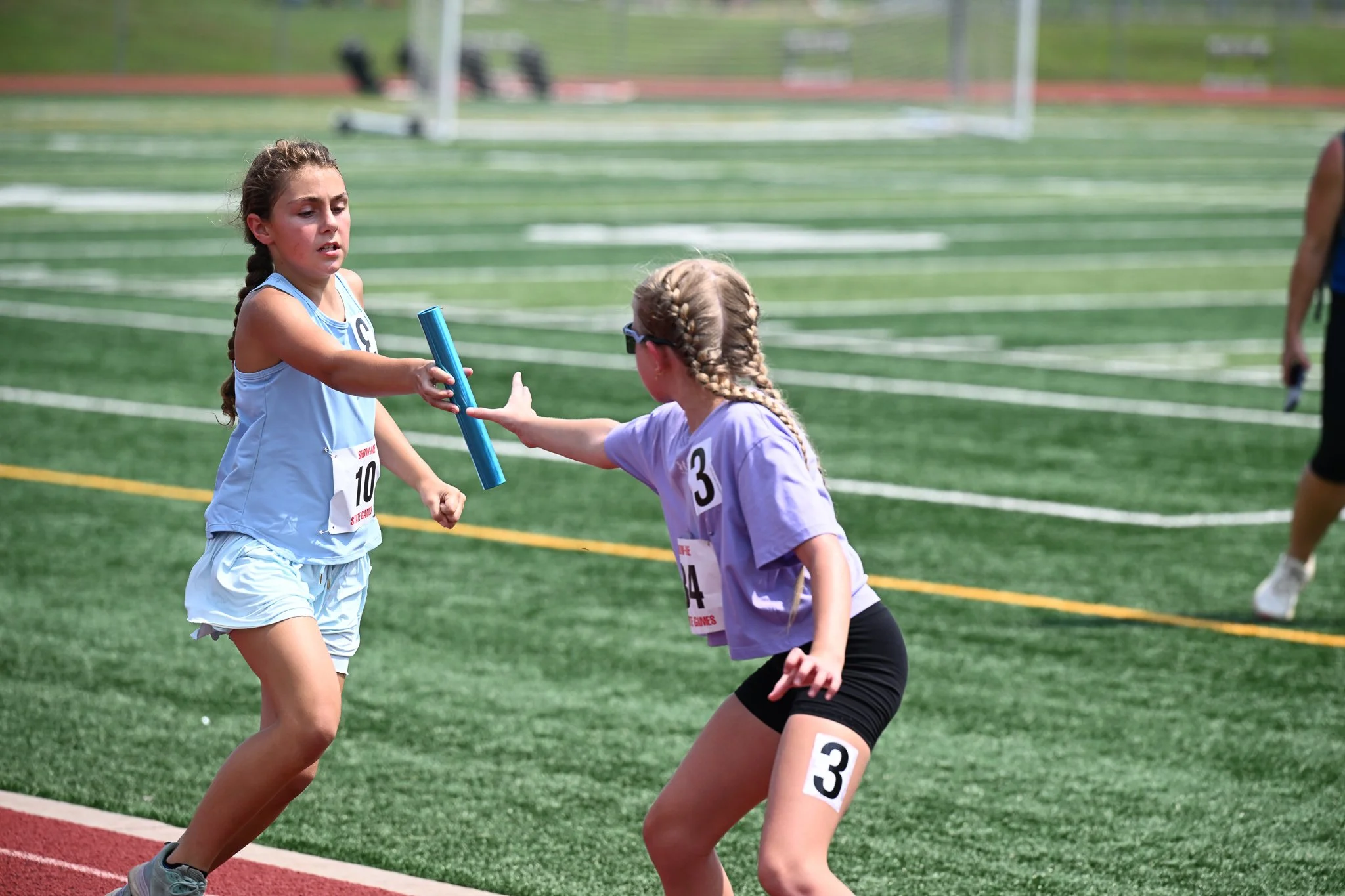 Katie Williams, 10, hands the baton off to Ava Kottwitz, 10, both from Unionville, Mo. in the final leg of the girls 4x400 relay race of the Show Me State games Track and field events on Saturday July 25, 2026, at Battle High School in Columbia. “I r