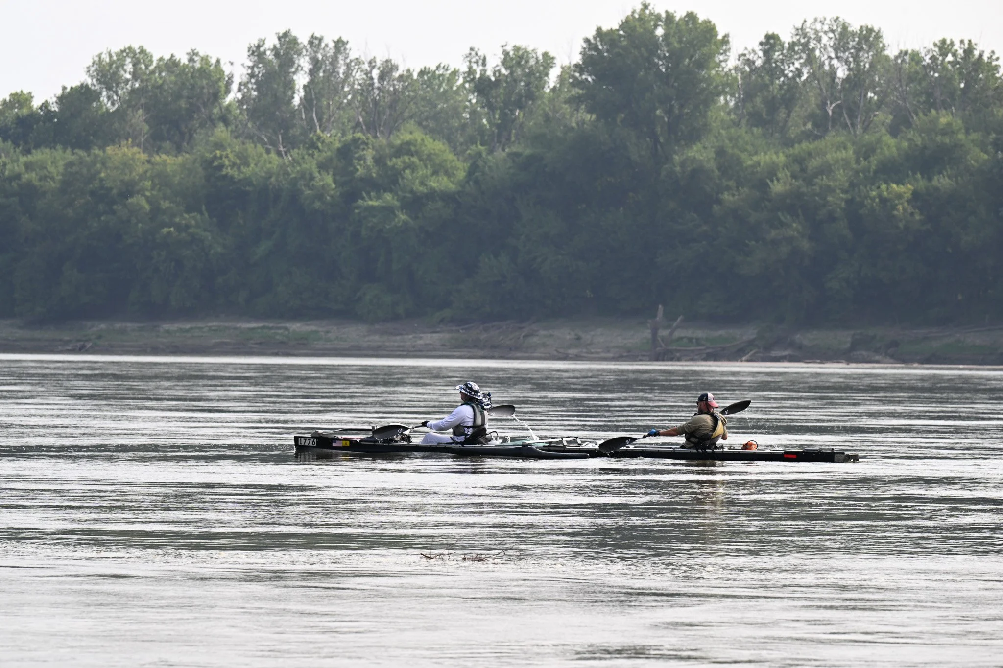 Trent Platz,left, from Kansas City, and Dustin Murphy, from Hartsburg, paddle their boat “Gadsdens Revenge” past Cooper’s Landing during the MR340 on Wednesday, July 29, 2026, in Columbia. Platz and Murphy are on pace to finish the race on Thursday e
