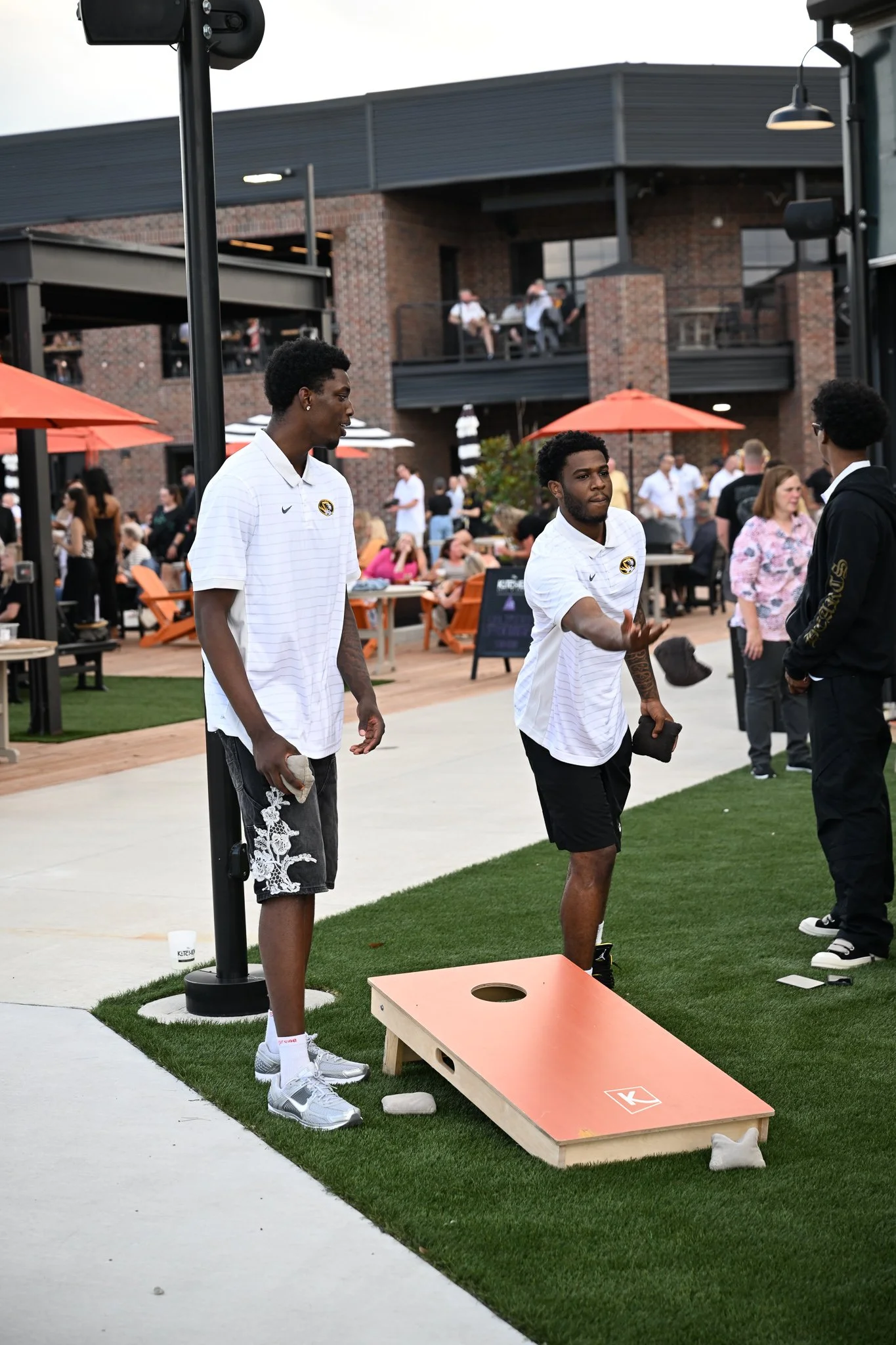 Mizzou basketball players Tony Bryant, left, and Jordan Crawford toss bags at the Zou to You event on Wednesday, June 24, 2026, at the Kitchen Bar and Grill in Columbia. Bryant and Crawford are part of Mizzou’s top ten recruiting class.