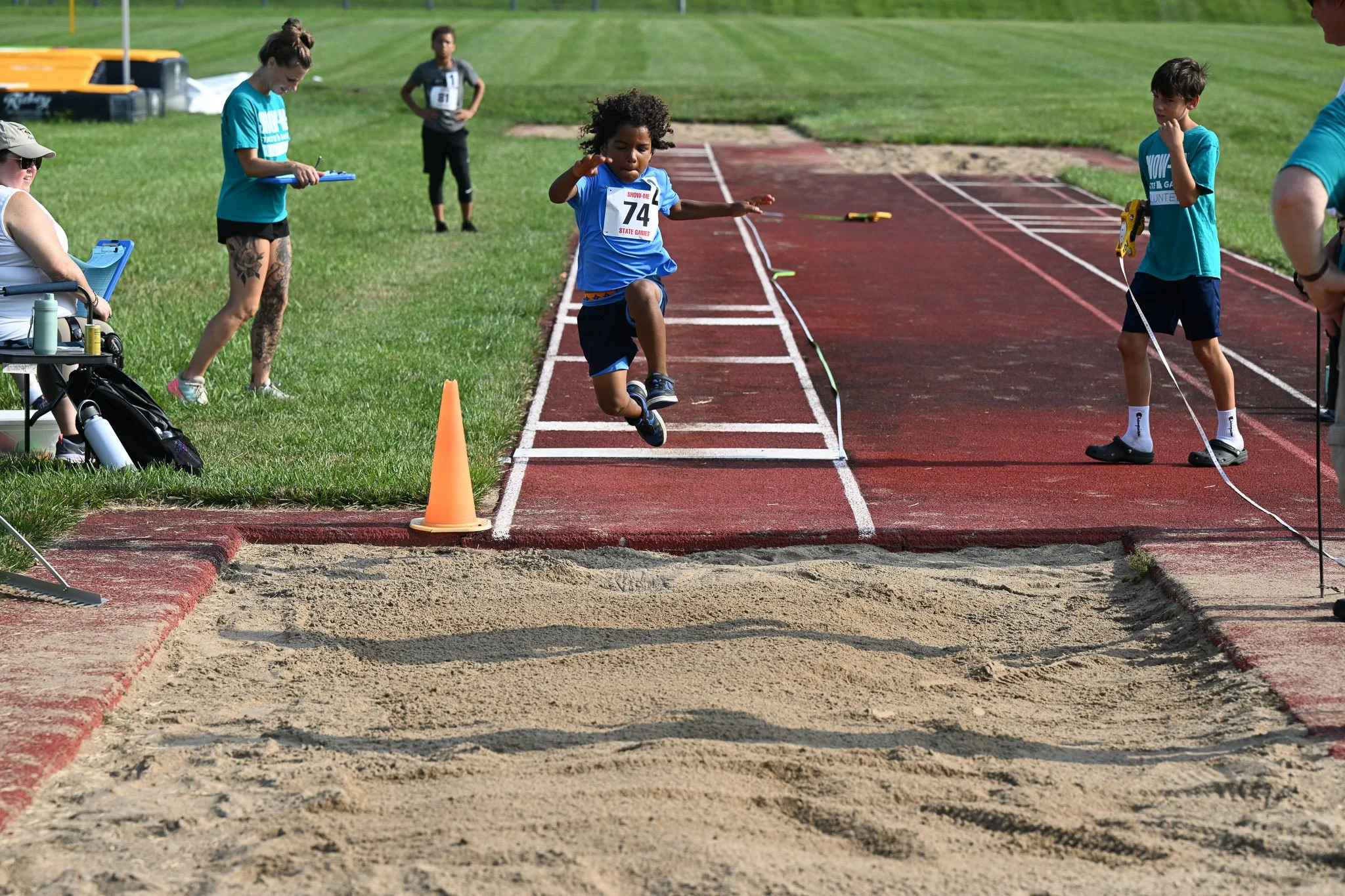 Donald Lloyd, 7, from Hamilton, MO, makes his long jump attempt during the Show Me State games Track and Field competition Saturday, July 25, 2026, at Battle High School in Columbia. “Last year, I had a bad year,” Donald said. “I wanted to make up fo