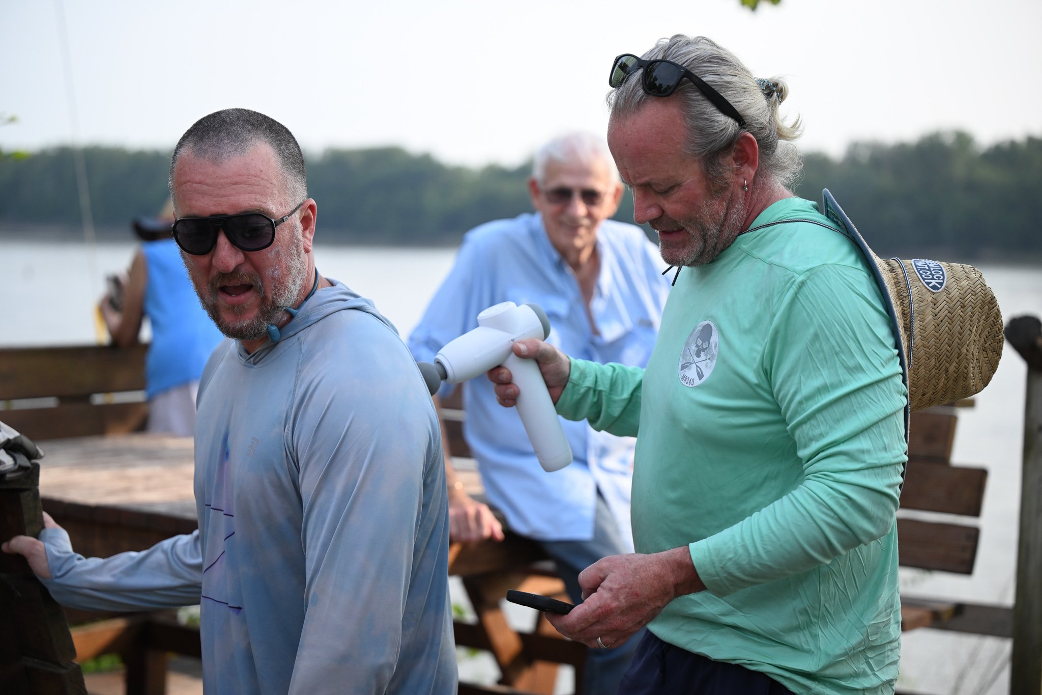 Jared Zillig, left, from Columbia, gets massaged by Morgan McNally, also of Columbia, to loosen up his shoulder muscles before returning to the river on Wednesday, July 29, 2026, at Cooper’s Landing in Columbia. McNally was there to support Zillig an