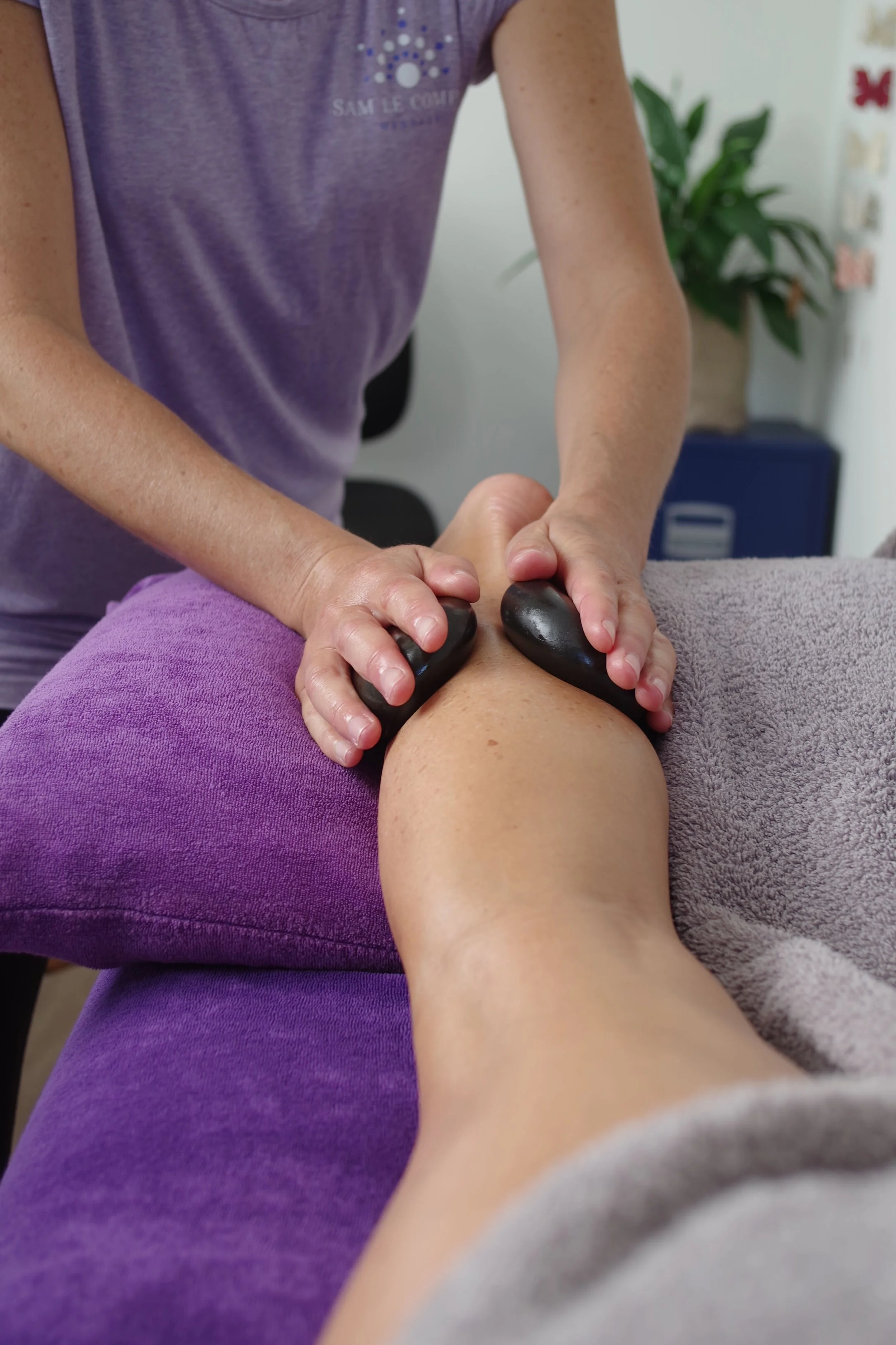Client Receiving Hot Stone Therapeutic Massage from Sam Le Compte