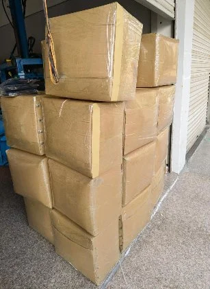 Boxes of donated hats and gloves for Riker's Island.