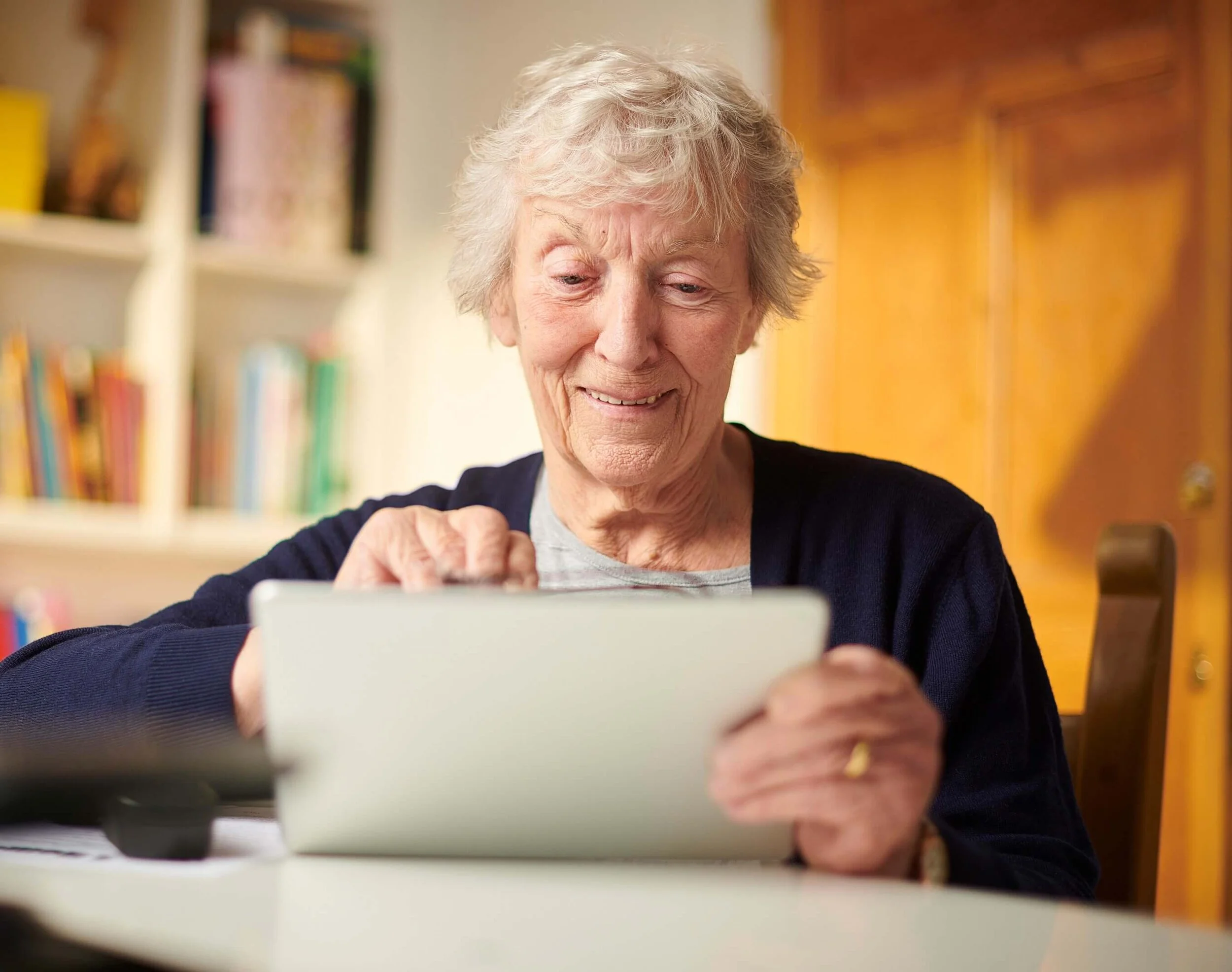 Older adult using a tablet.