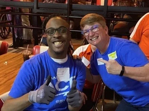 Two people giving a thumbs up.