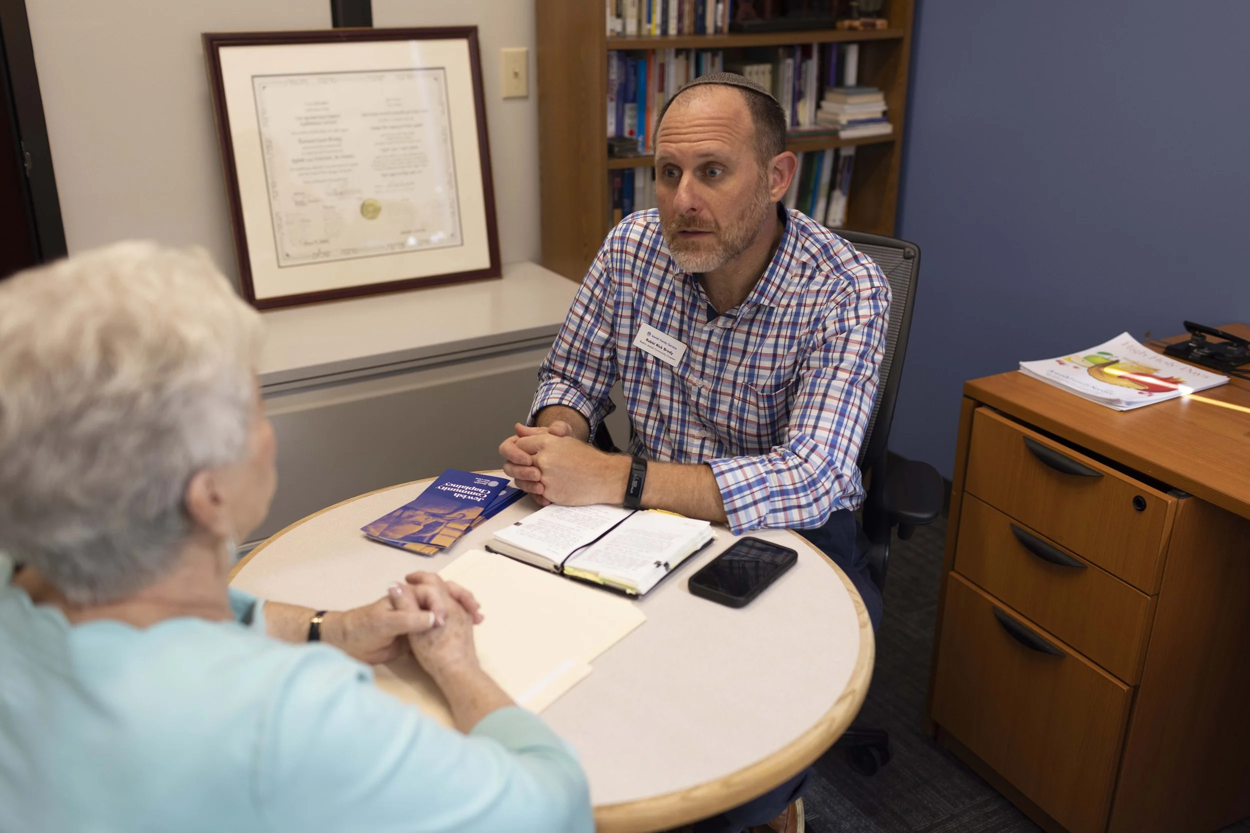 Rabbi talking with a person.