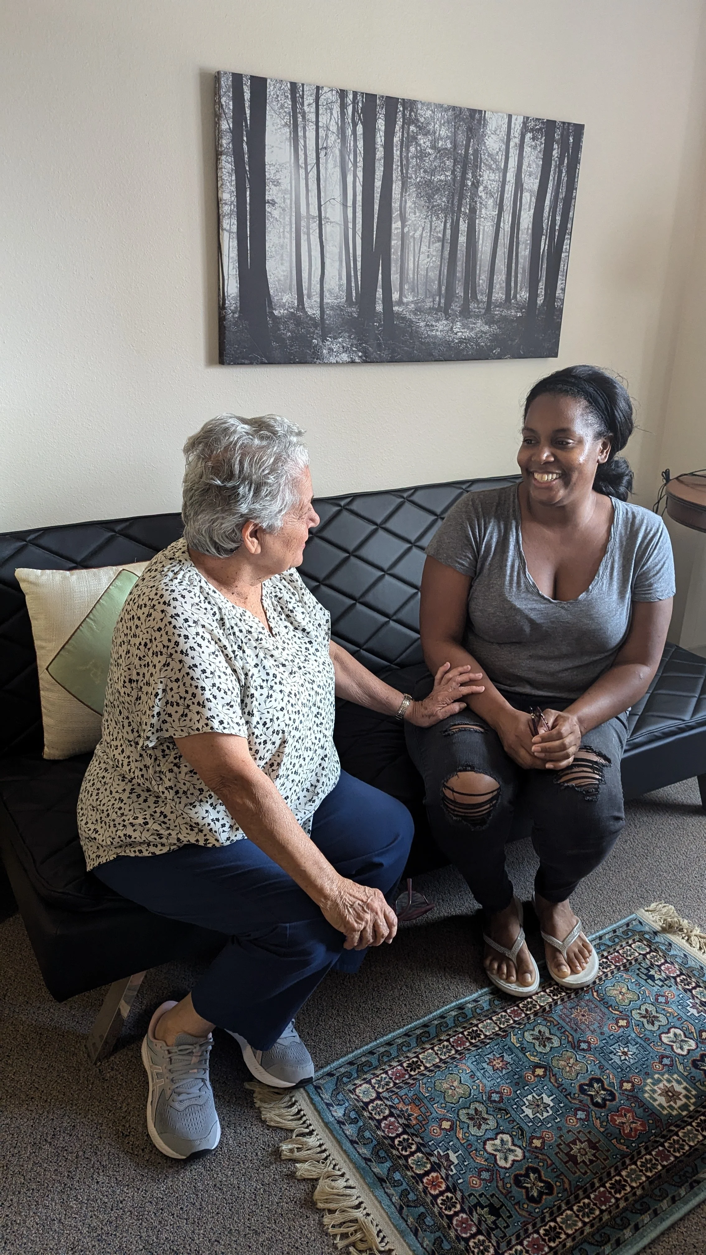 Two people sitting on a couch.