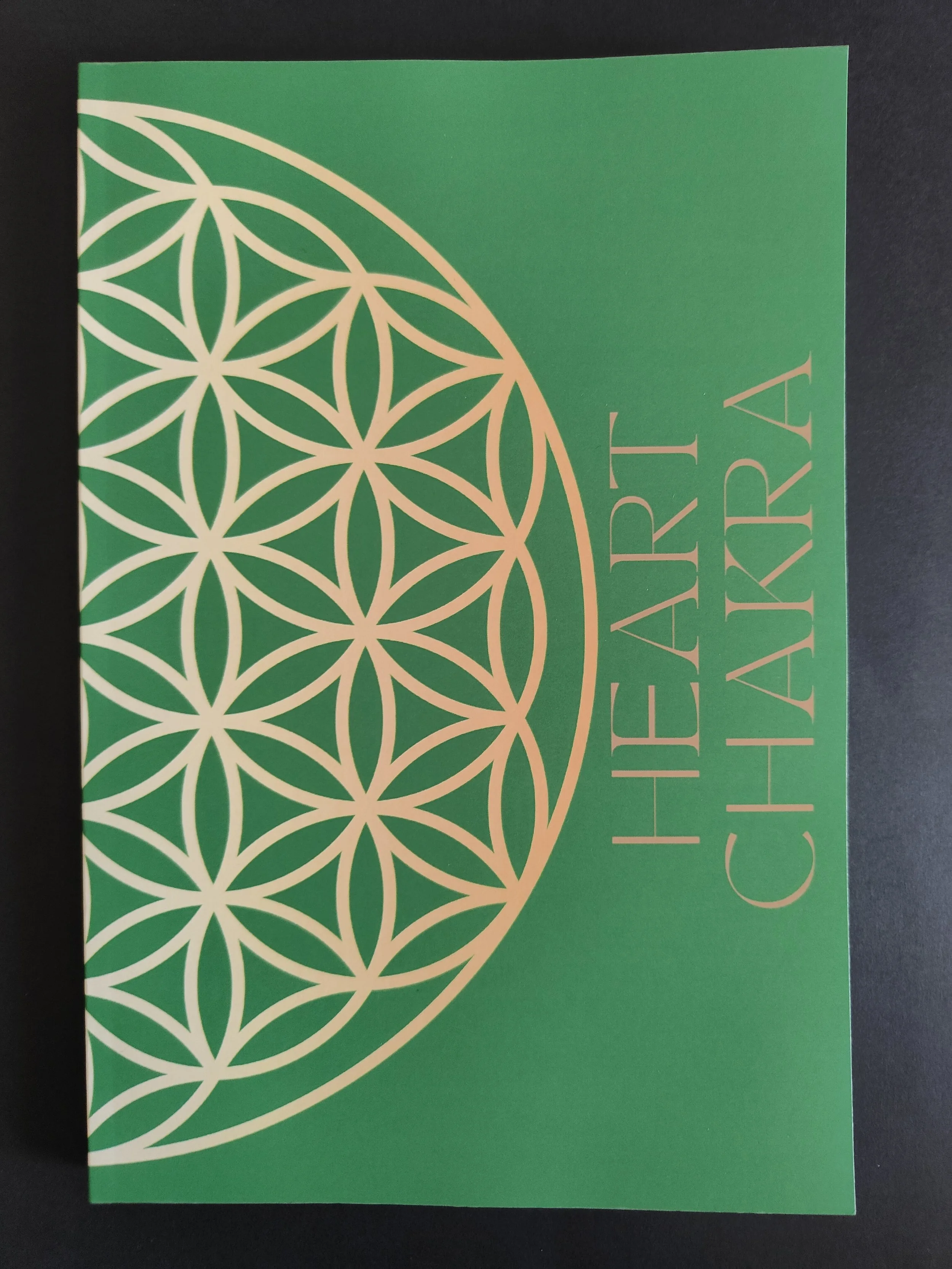 Green booklet cover with white geometric circular pattern and the text 'HEART CENTER CHAVARA' on the right side.