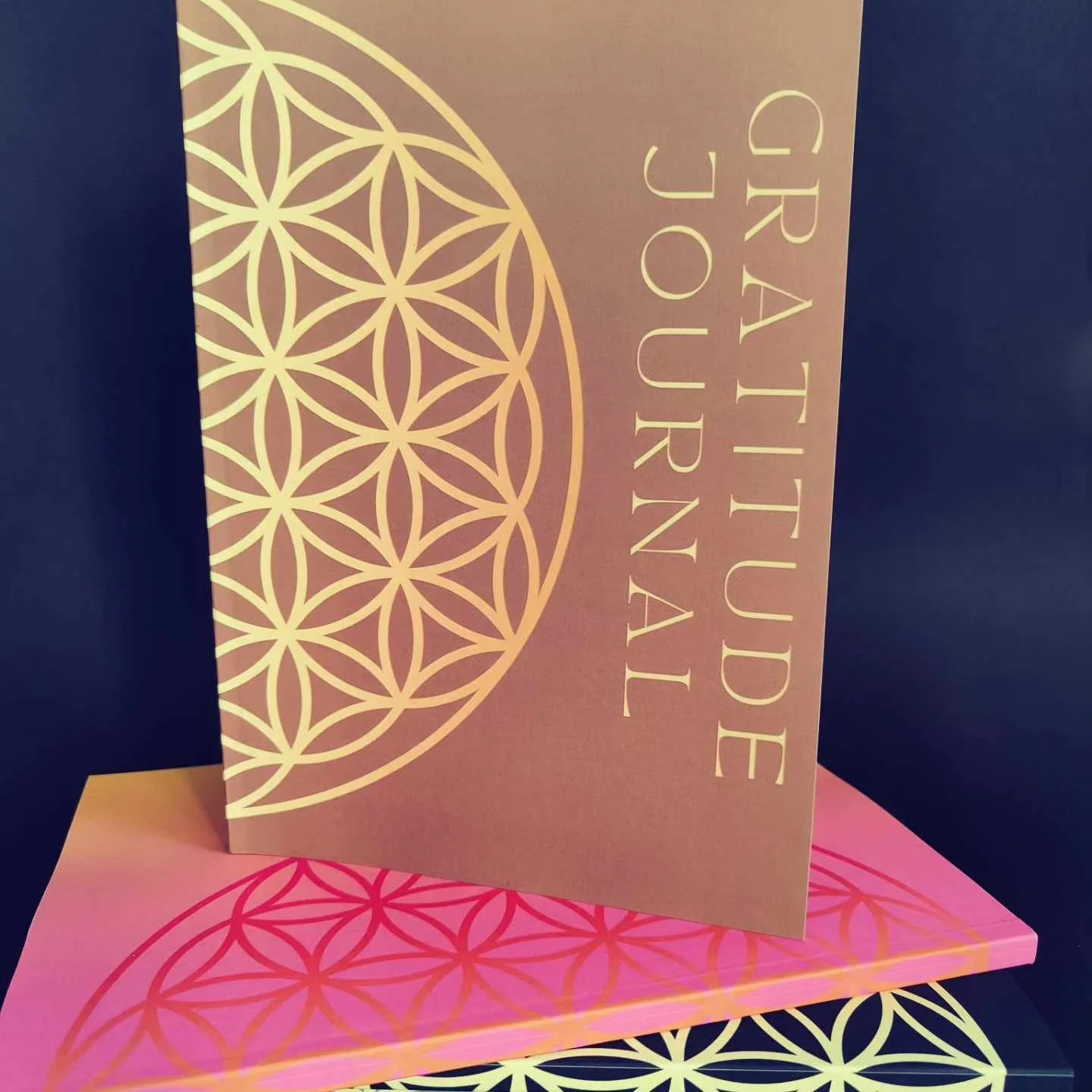 A card and envelope set with gold and pink geometric designs and the words "Gratitude Journal" in gold lettering.