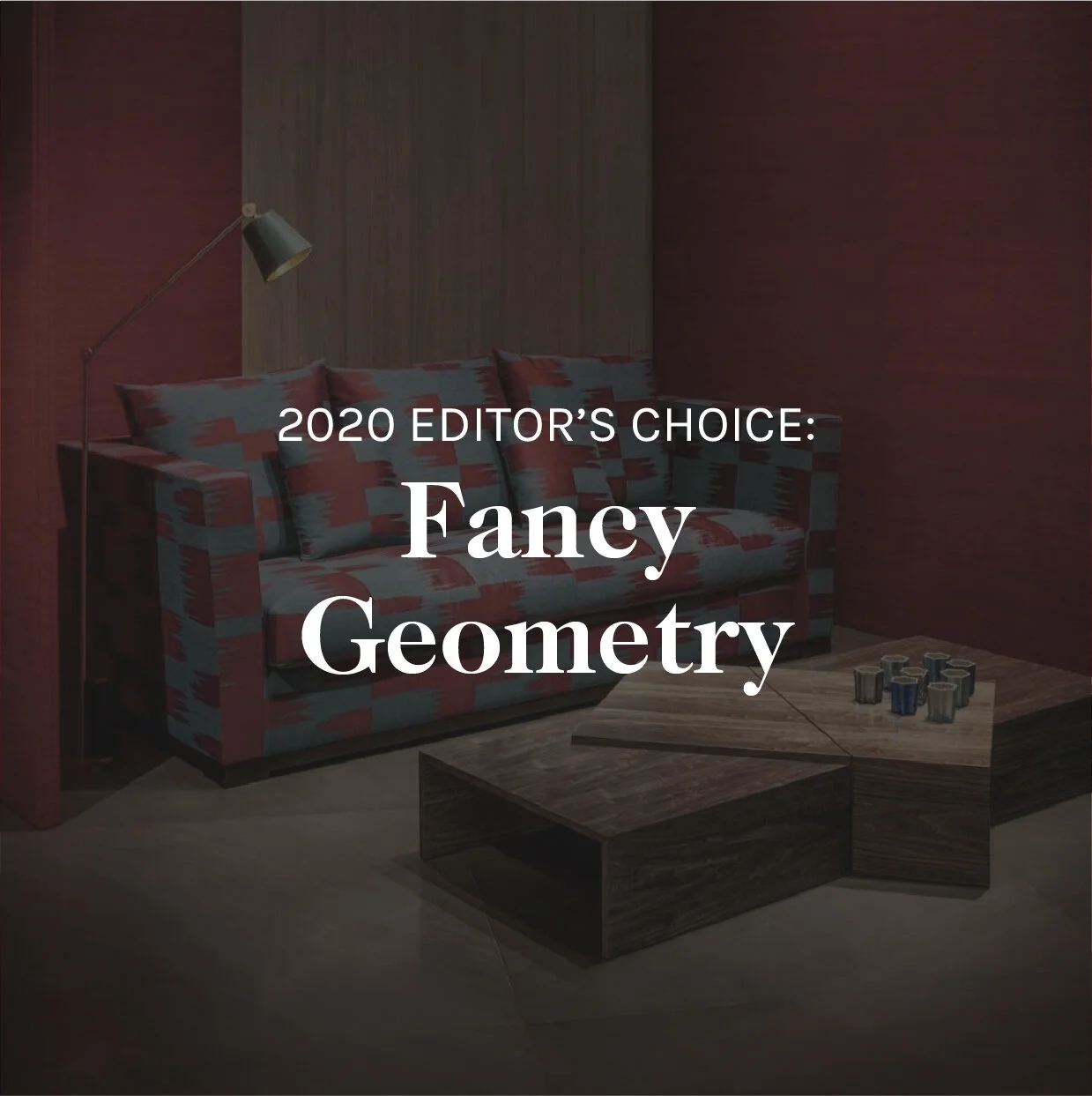 A living room with a patterned sofa, wooden coffee table, and a floor lamp on a red and brown wall background, with text overlay indicating '2020 Editor's Choice: Fancy Geometry'.