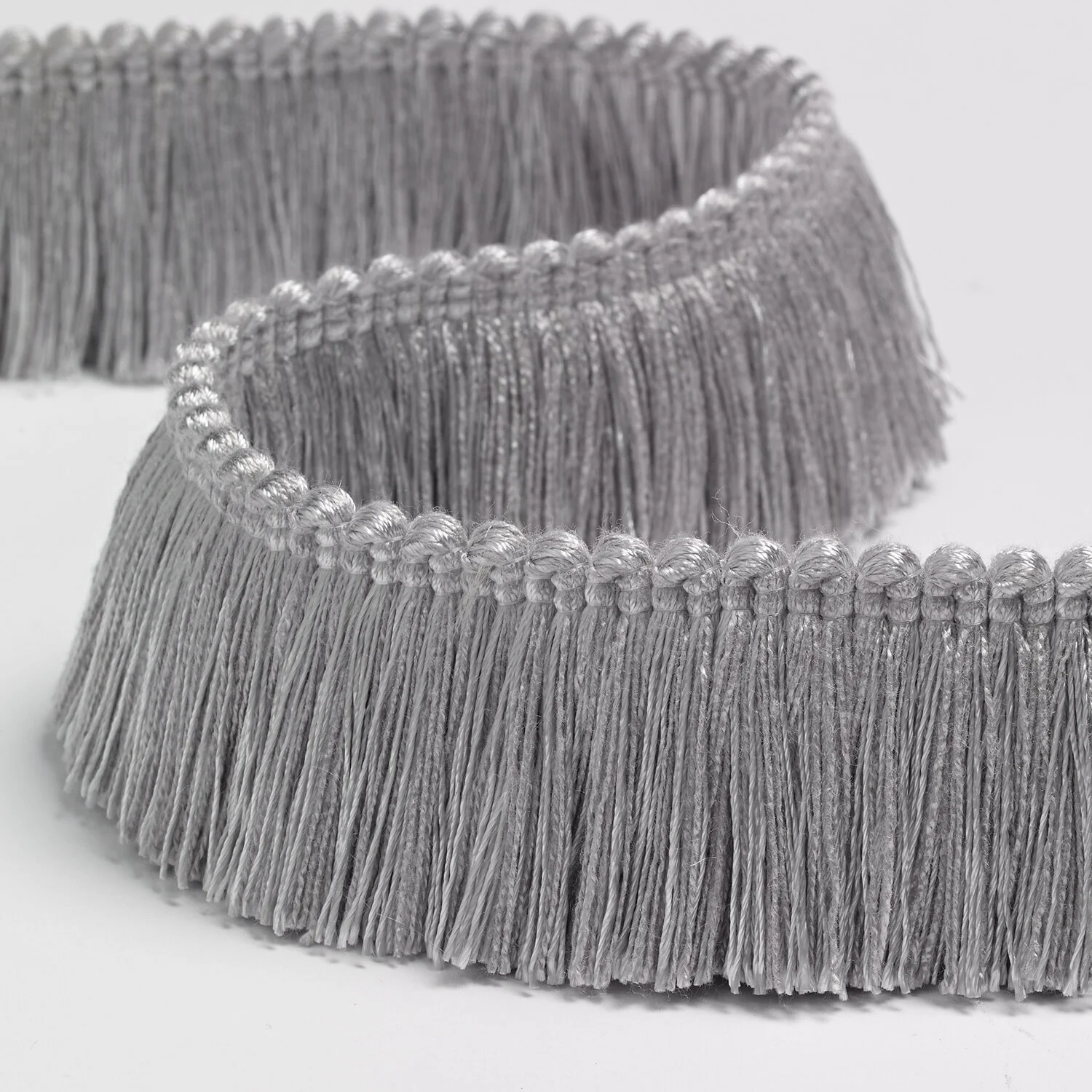 Close-up of two silver metallic hairbrushes with fine bristles, placed on a white background.